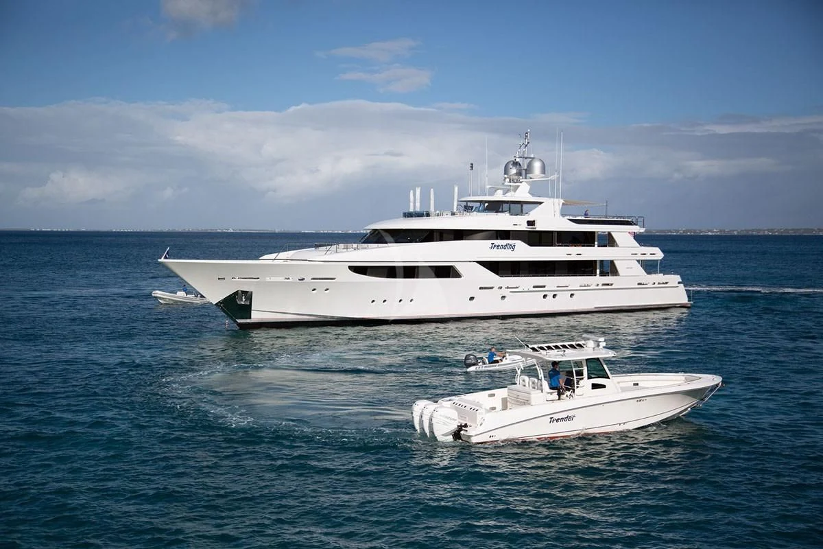 a couple of white yachts in the ocean aboard TRENDING Yacht for Sale