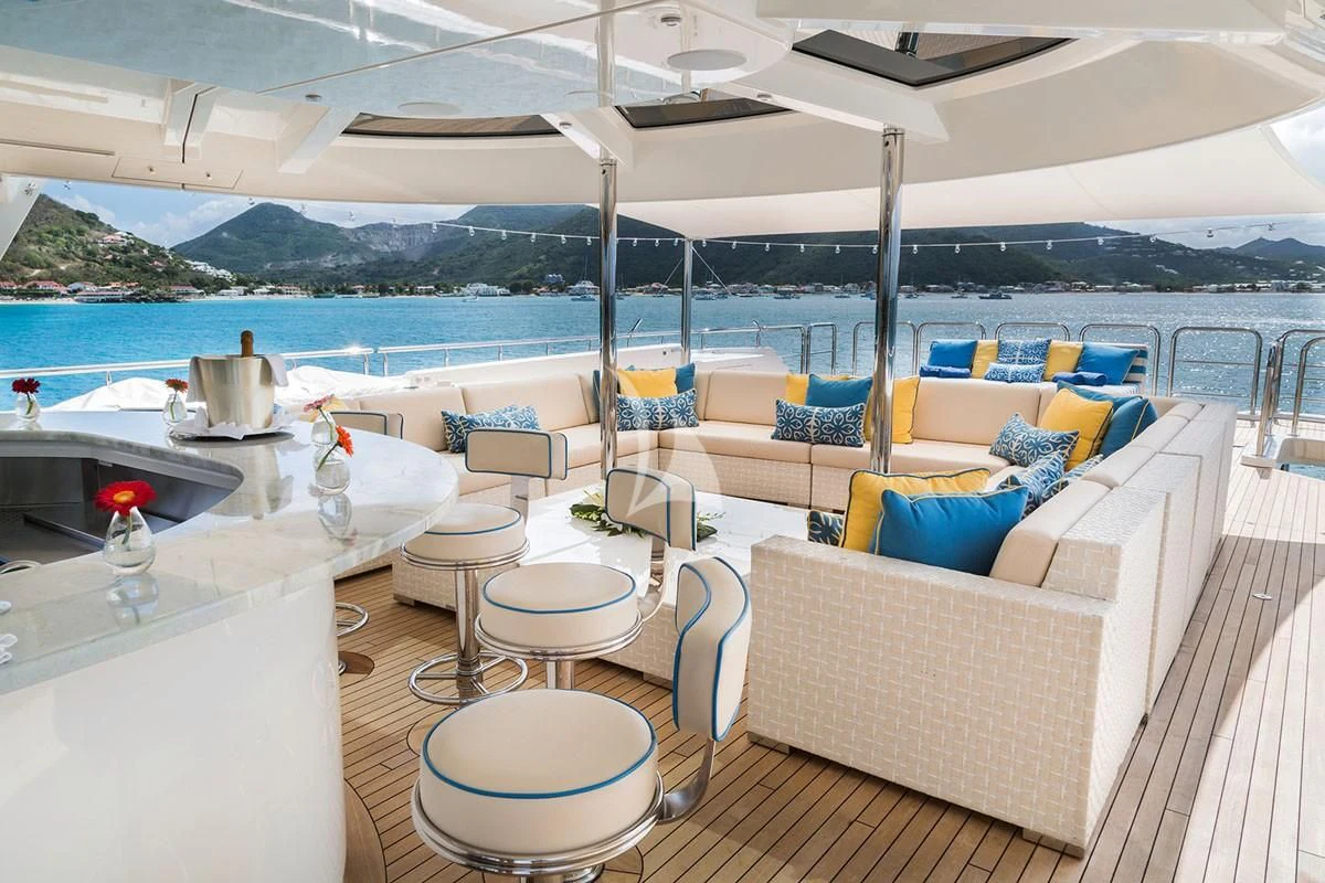 a lounge area with a table and chairs on it aboard TRENDING Yacht for Sale