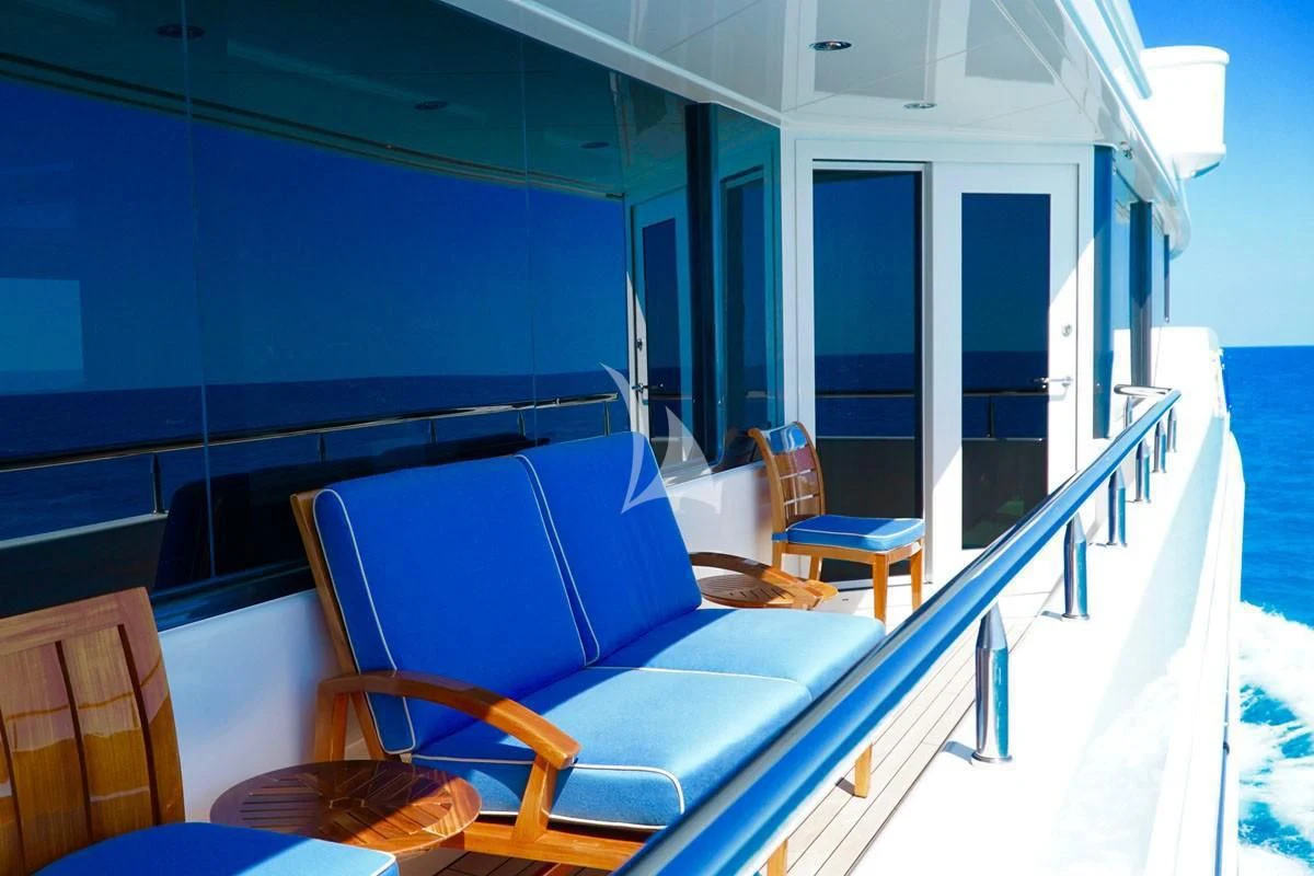 a balcony with chairs and a table aboard TRENDING Yacht for Sale