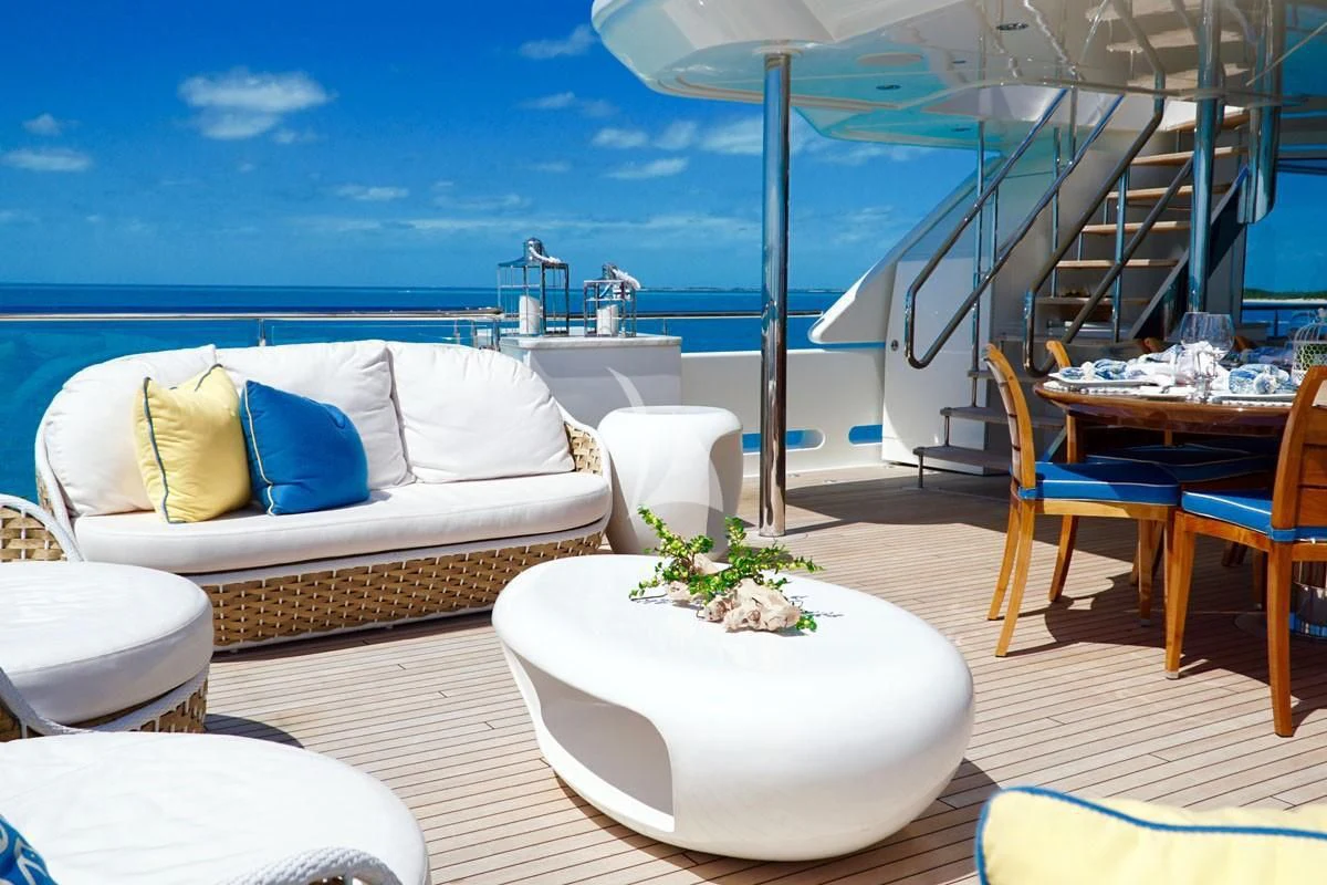 a room with a couch and a table and chairs aboard TRENDING Yacht for Sale