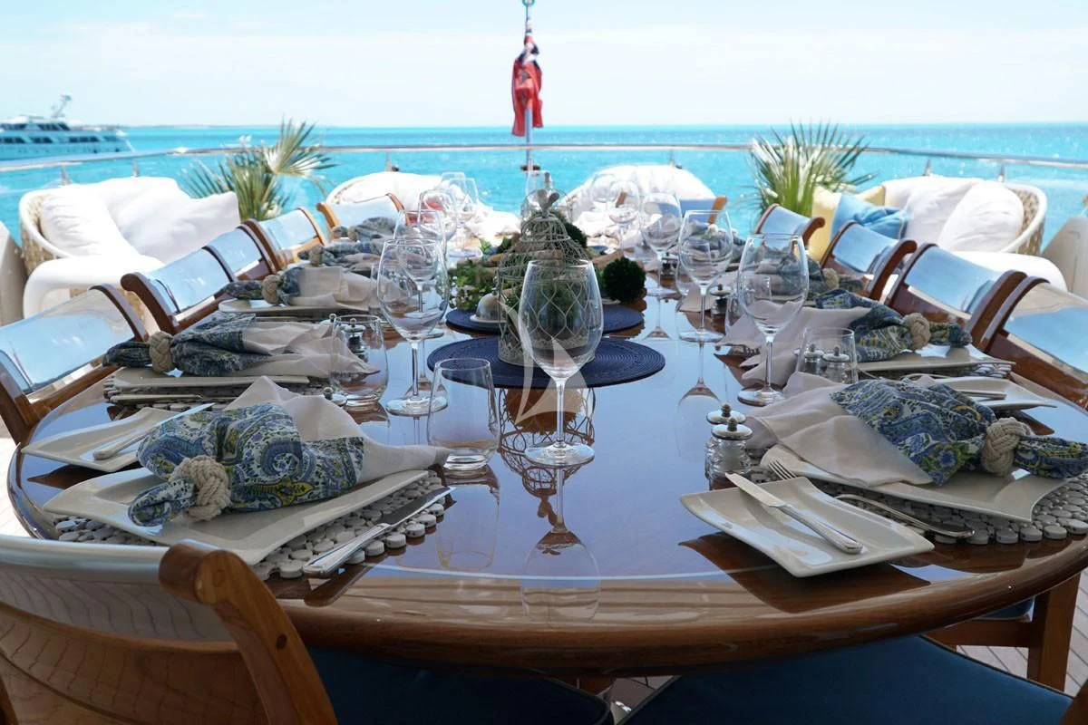 a table with plates and silverware on it aboard TRENDING Yacht for Sale