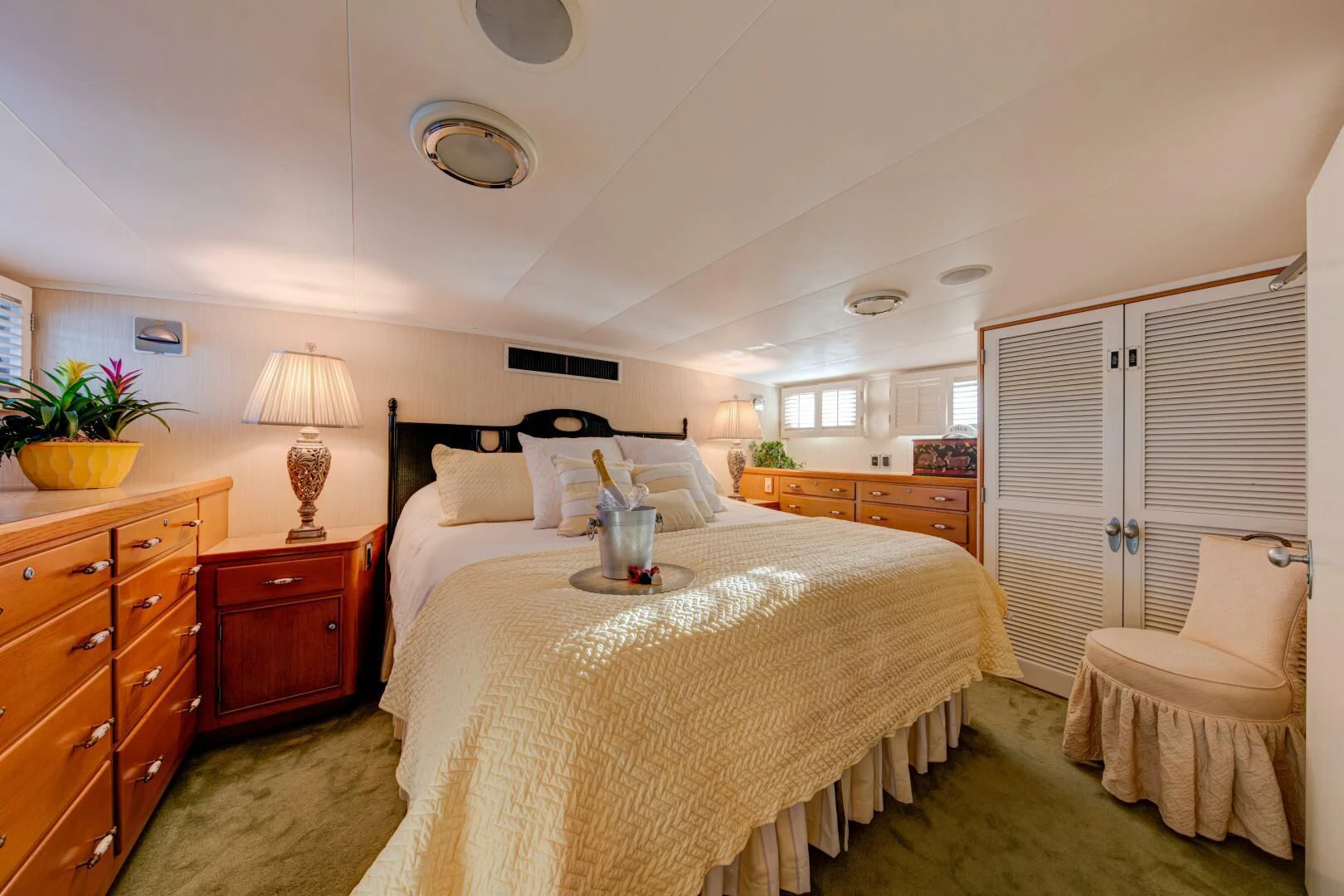 a bedroom with a bed and a chair aboard KOALA Yacht for Sale