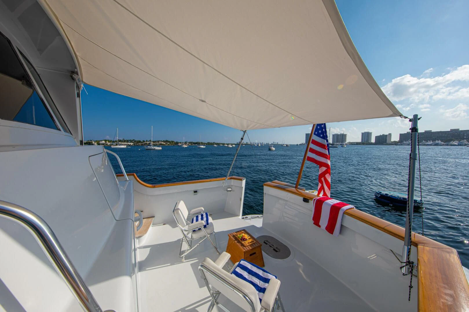 a boat with a flag on the front aboard KOALA Yacht for Sale