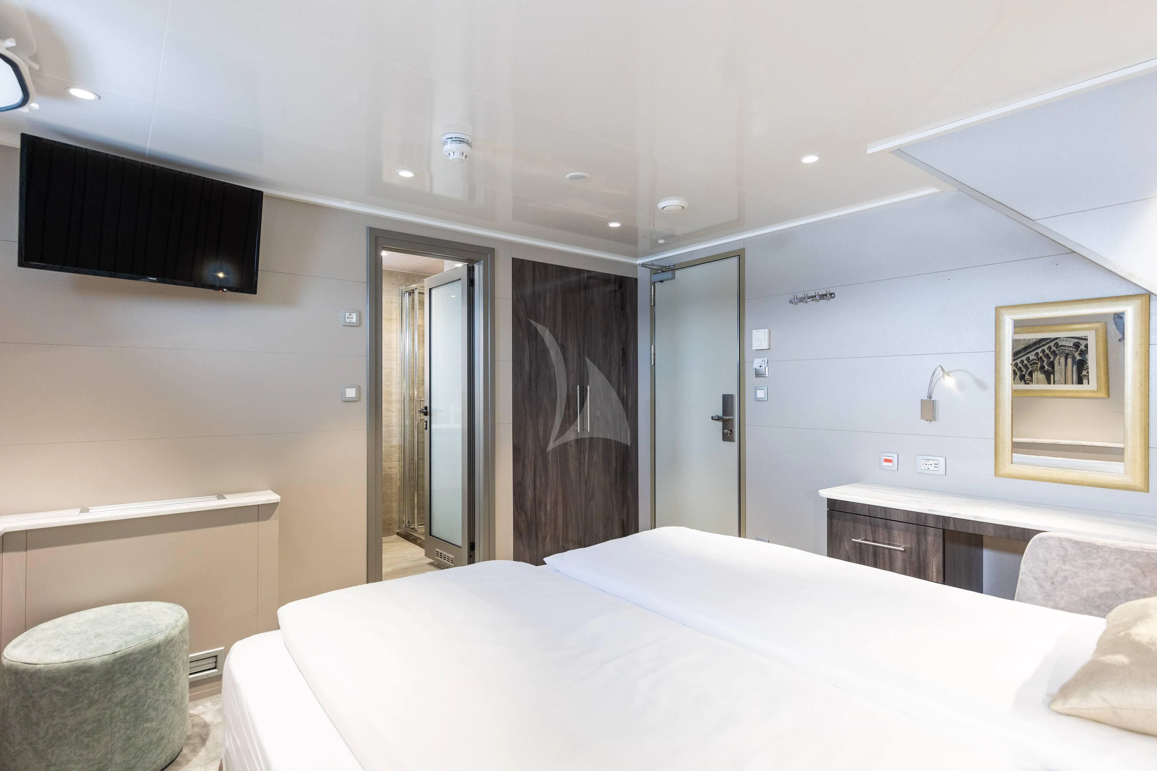 a bedroom with a bed and a television aboard LADY ELEGANZA Yacht for Sale