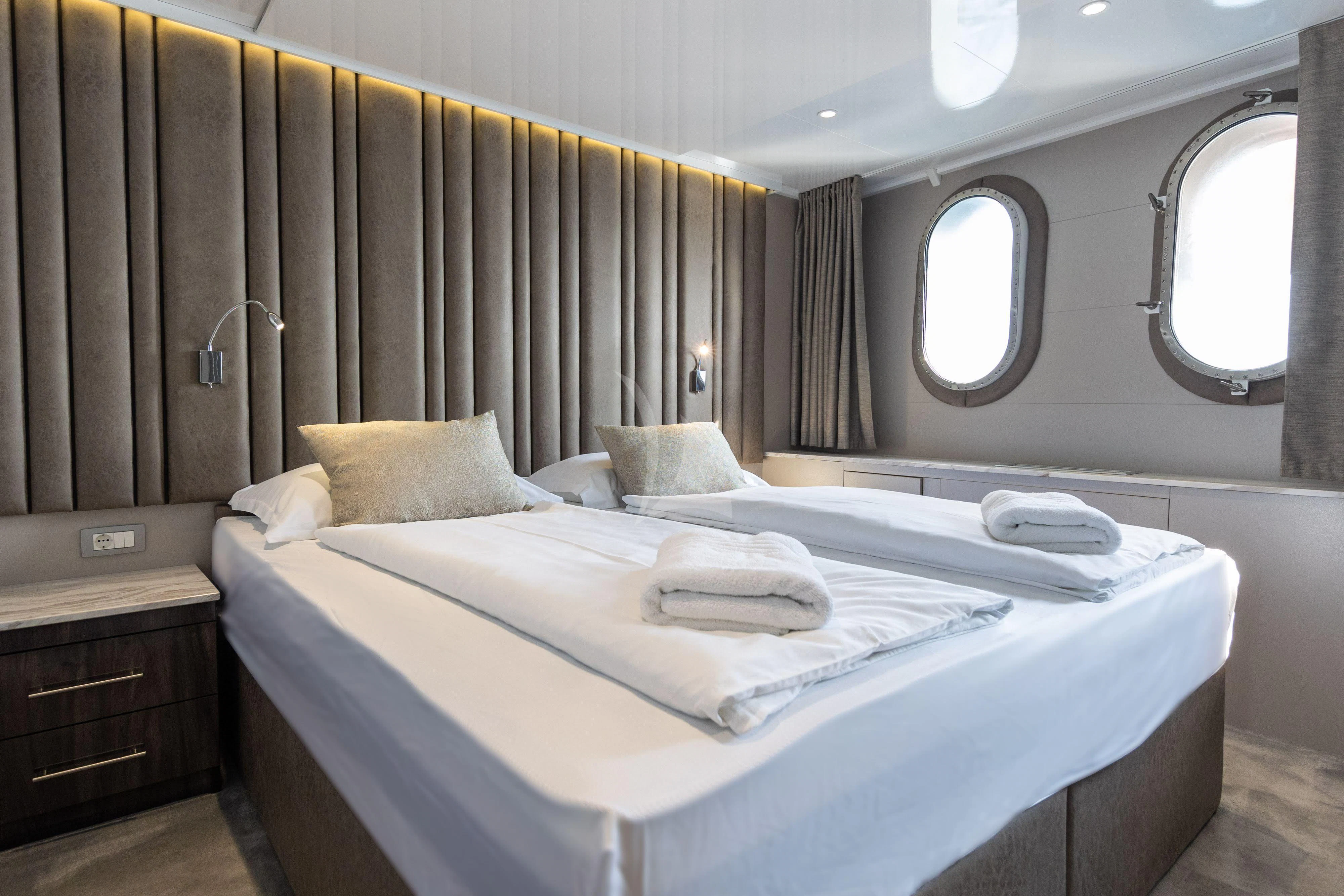 a hotel room with a bed and a mirror aboard LADY ELEGANZA Yacht for Sale