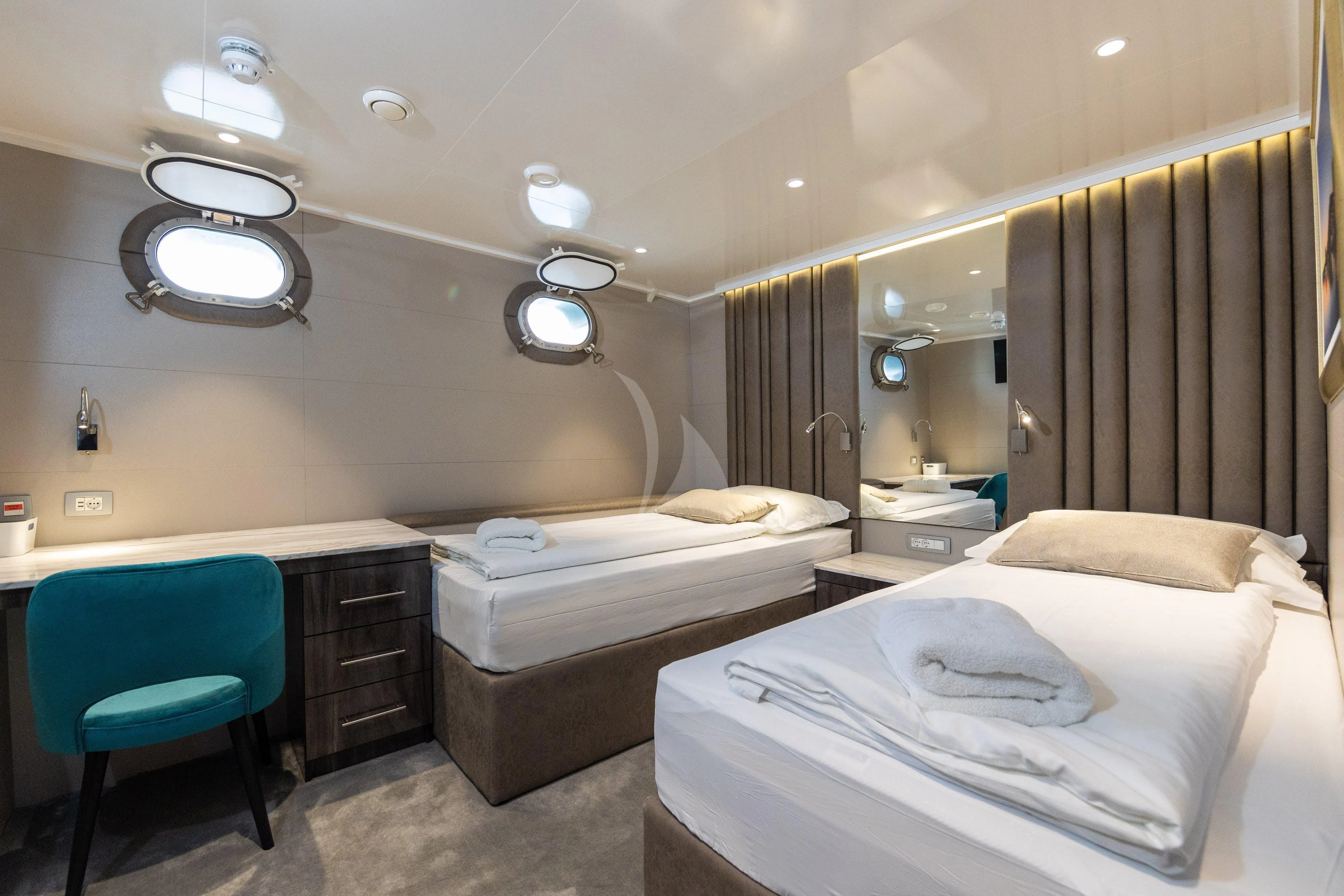 a room with a couple of beds aboard LADY ELEGANZA Yacht for Sale