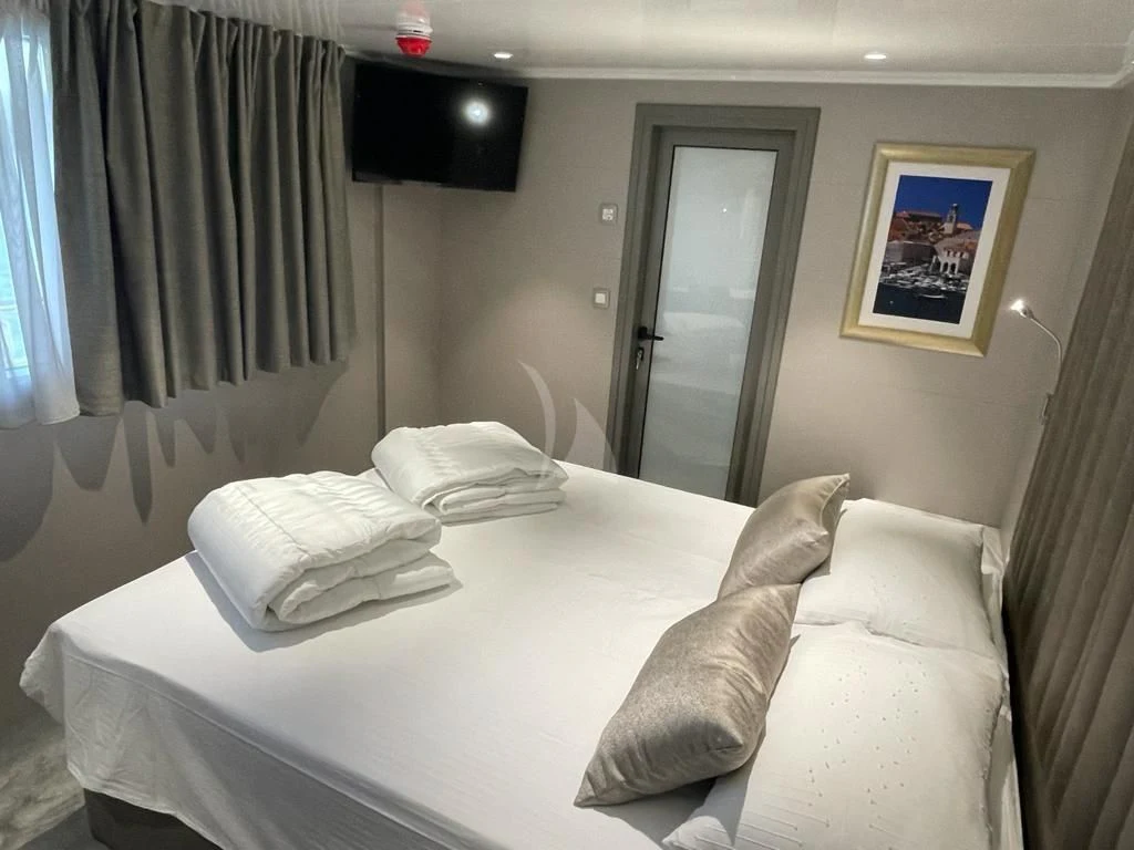a bed with white sheets aboard LADY ELEGANZA Yacht for Sale