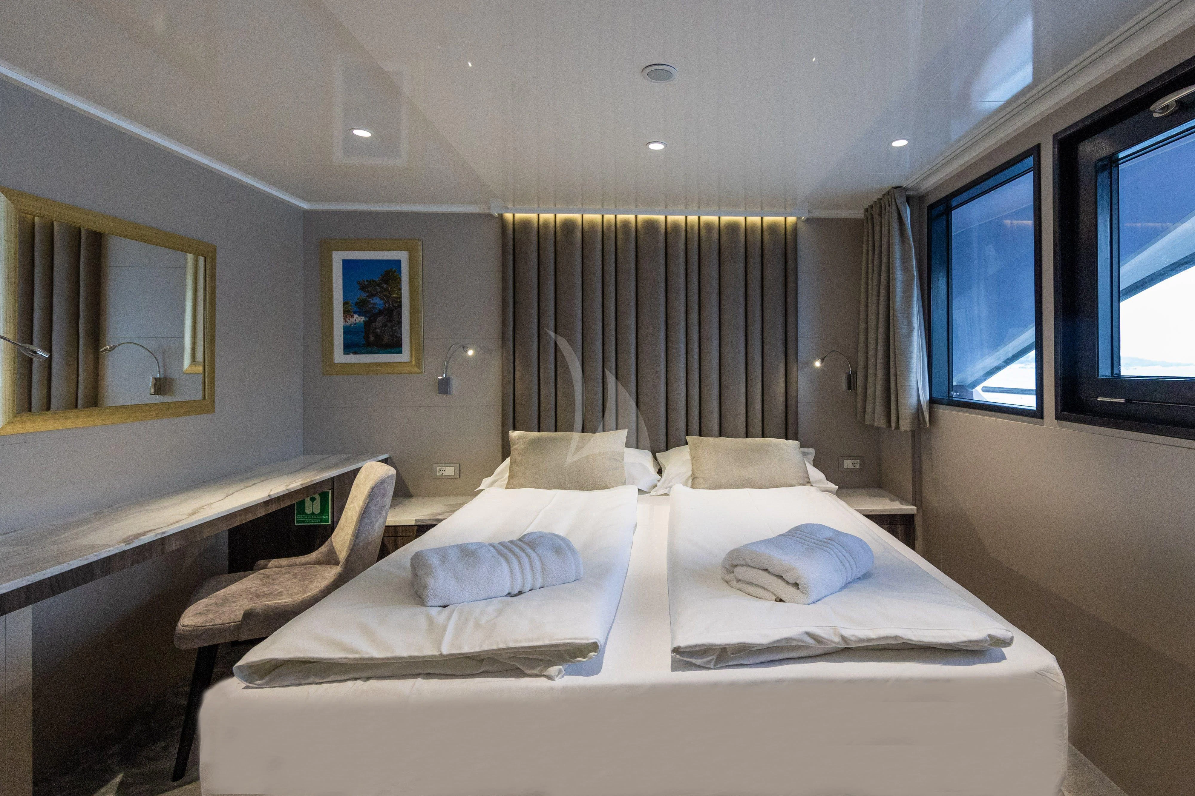 a room with a bed and a window aboard LADY ELEGANZA Yacht for Sale