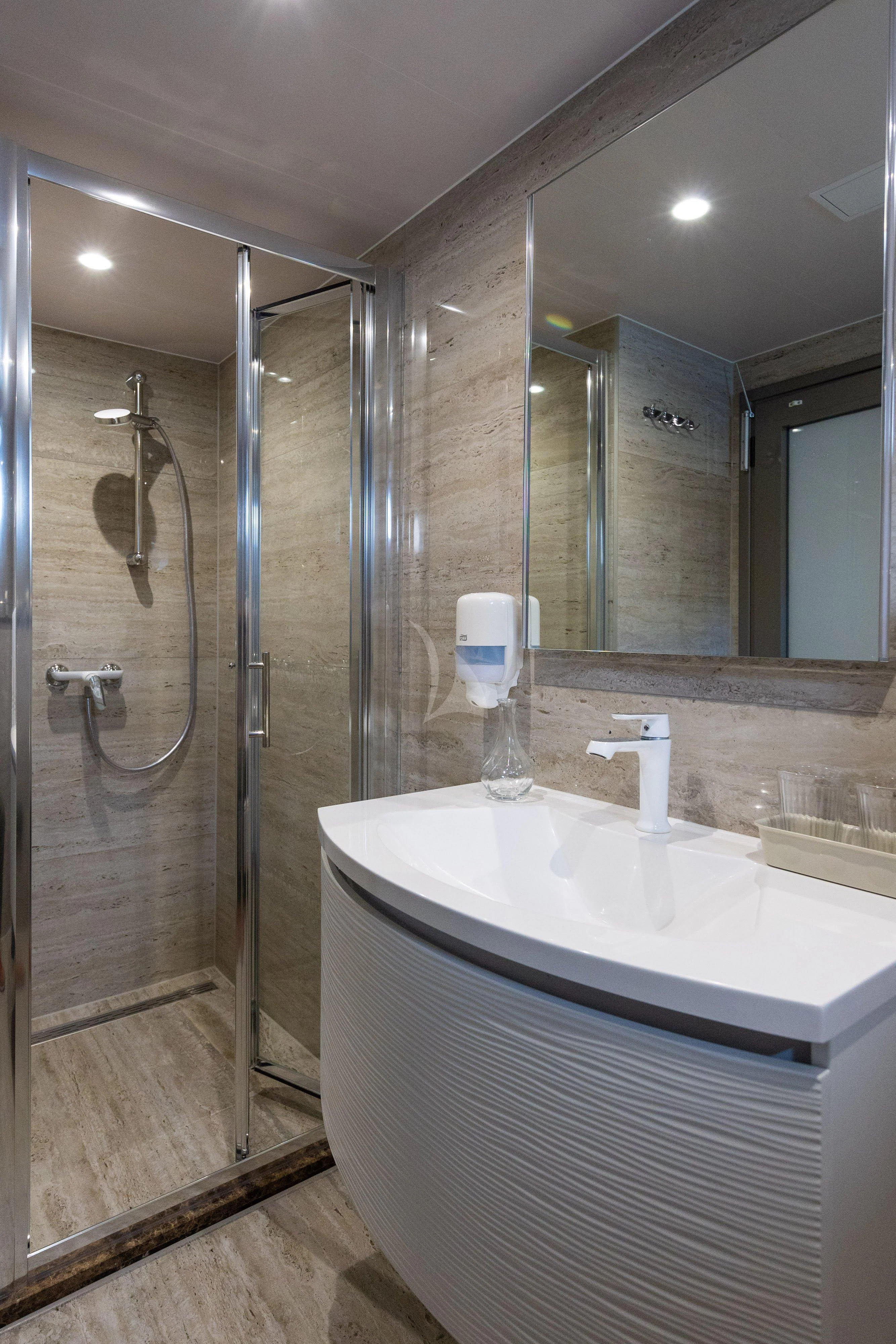 a bathroom with a glass shower aboard LADY ELEGANZA Yacht for Sale