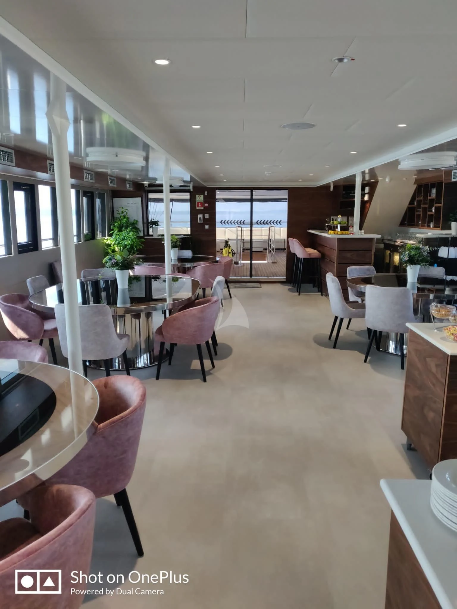 a room with tables and chairs aboard LADY ELEGANZA Yacht for Sale