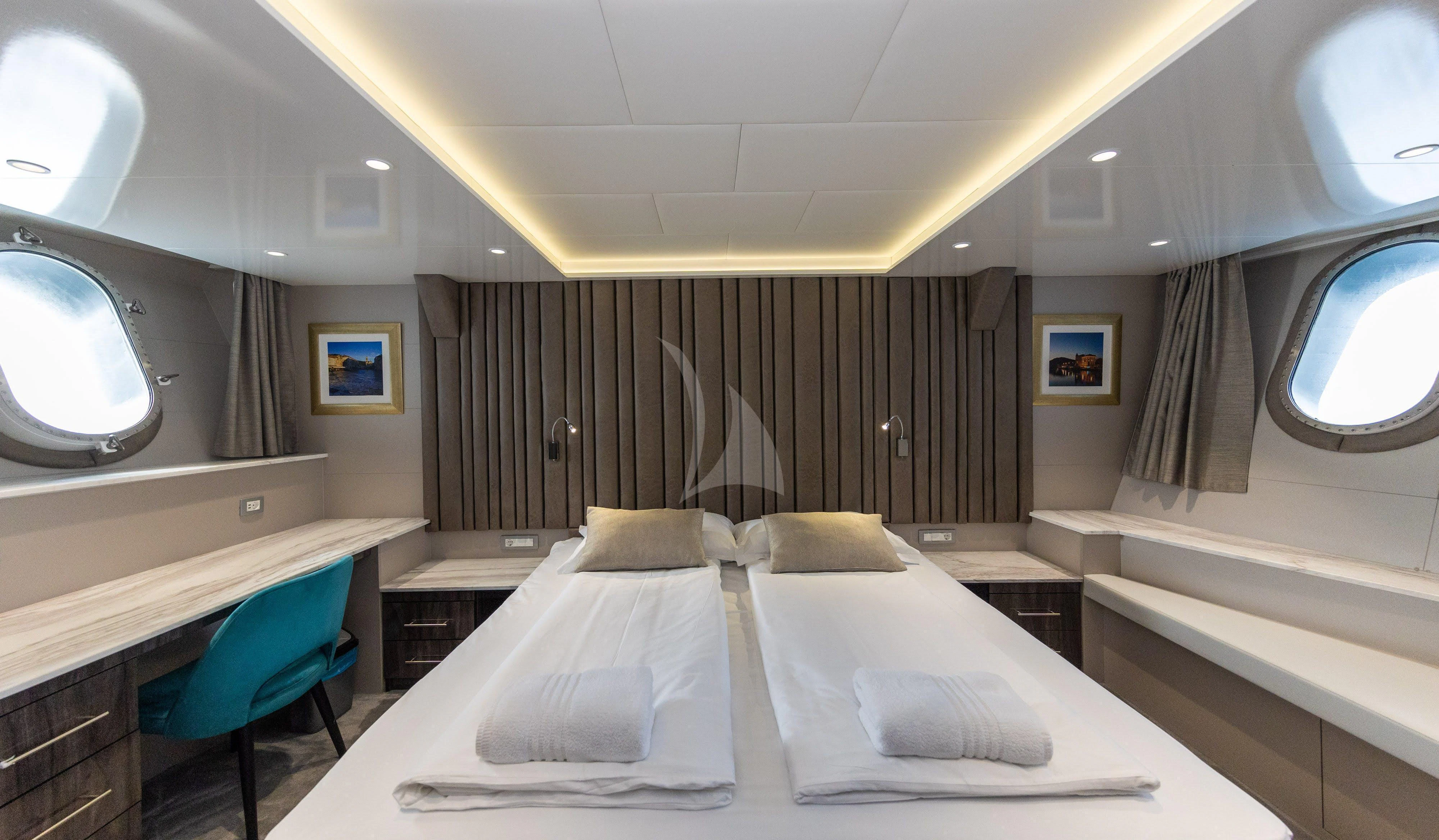 a room with a bed and a chair aboard LADY ELEGANZA Yacht for Sale