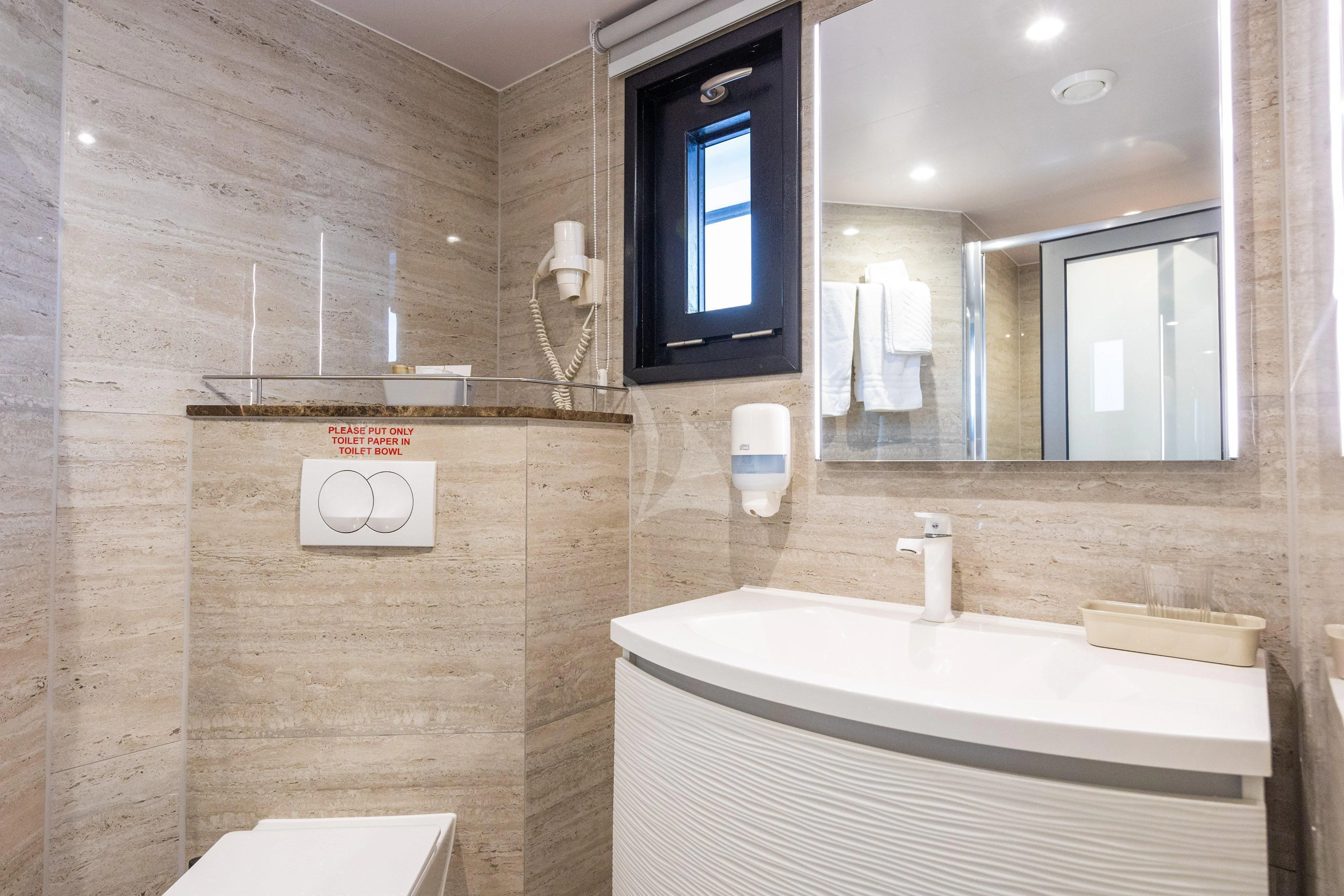 a bathroom with a tub and a sink aboard LADY ELEGANZA Yacht for Sale