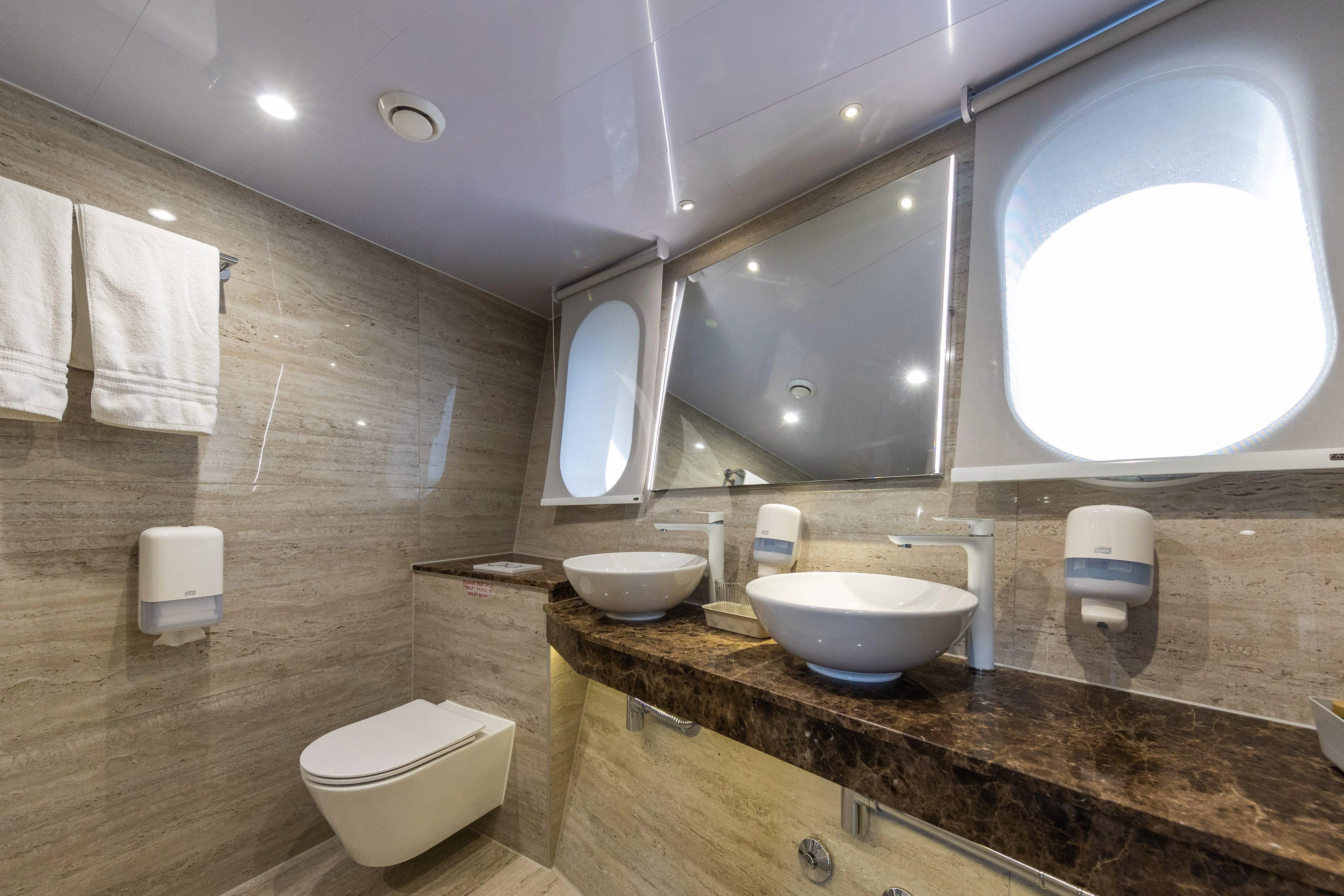 a bathroom with a large mirror aboard LADY ELEGANZA Yacht for Sale