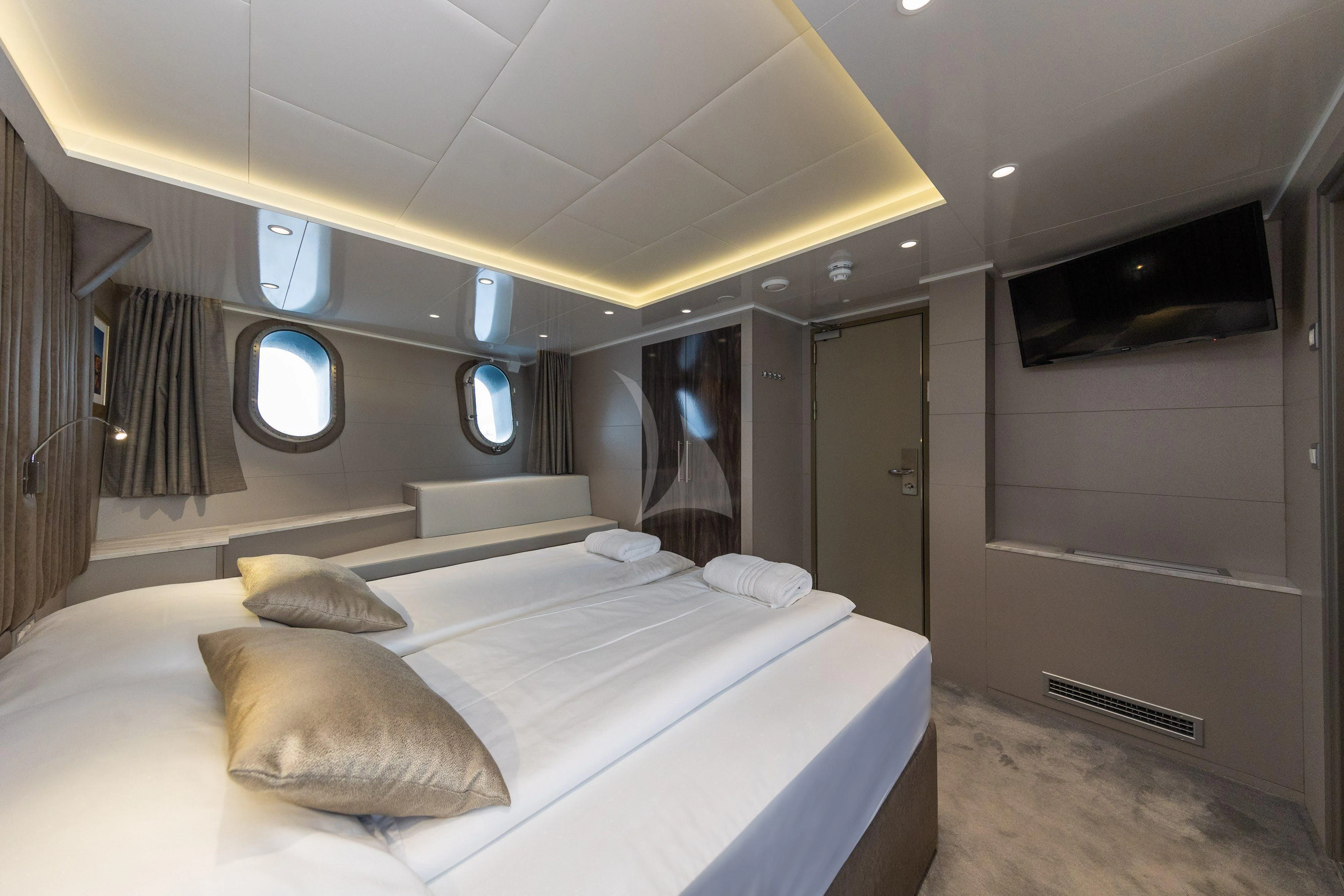 a room with a bed and a mirror aboard LADY ELEGANZA Yacht for Sale