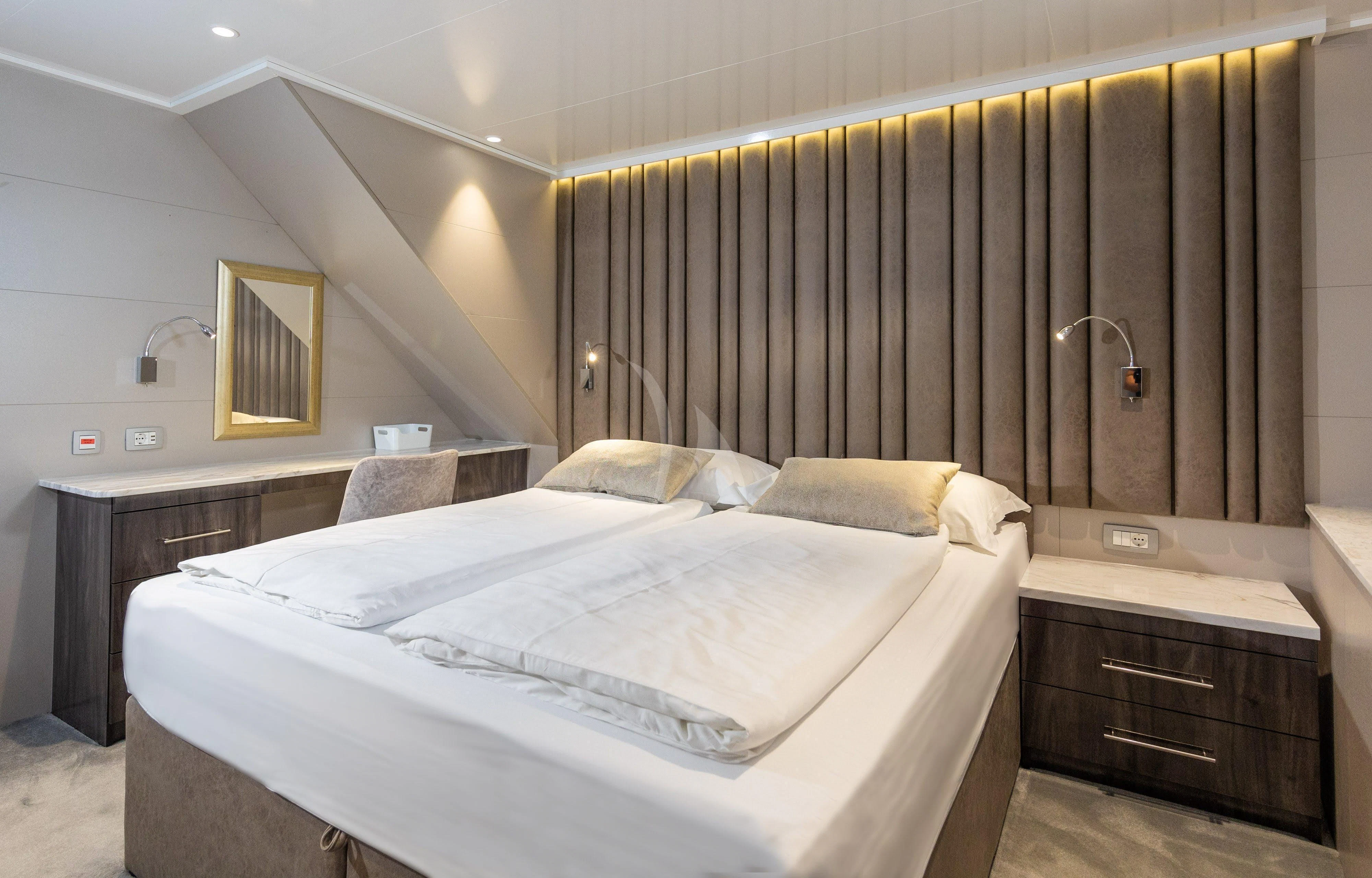 a room with a bed and a desk aboard LADY ELEGANZA Yacht for Sale