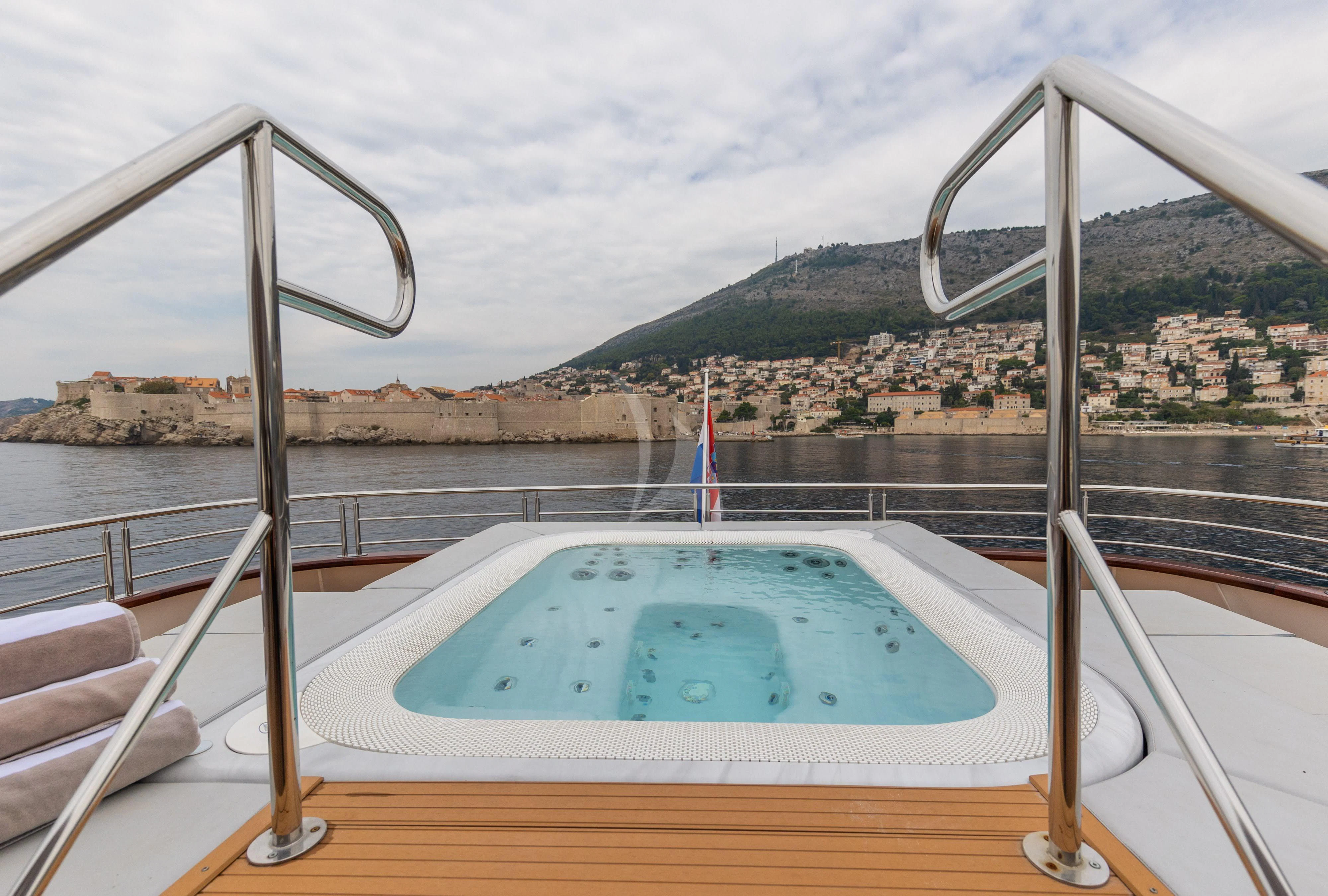 a pool on a deck overlooking a city aboard LADY ELEGANZA Yacht for Sale