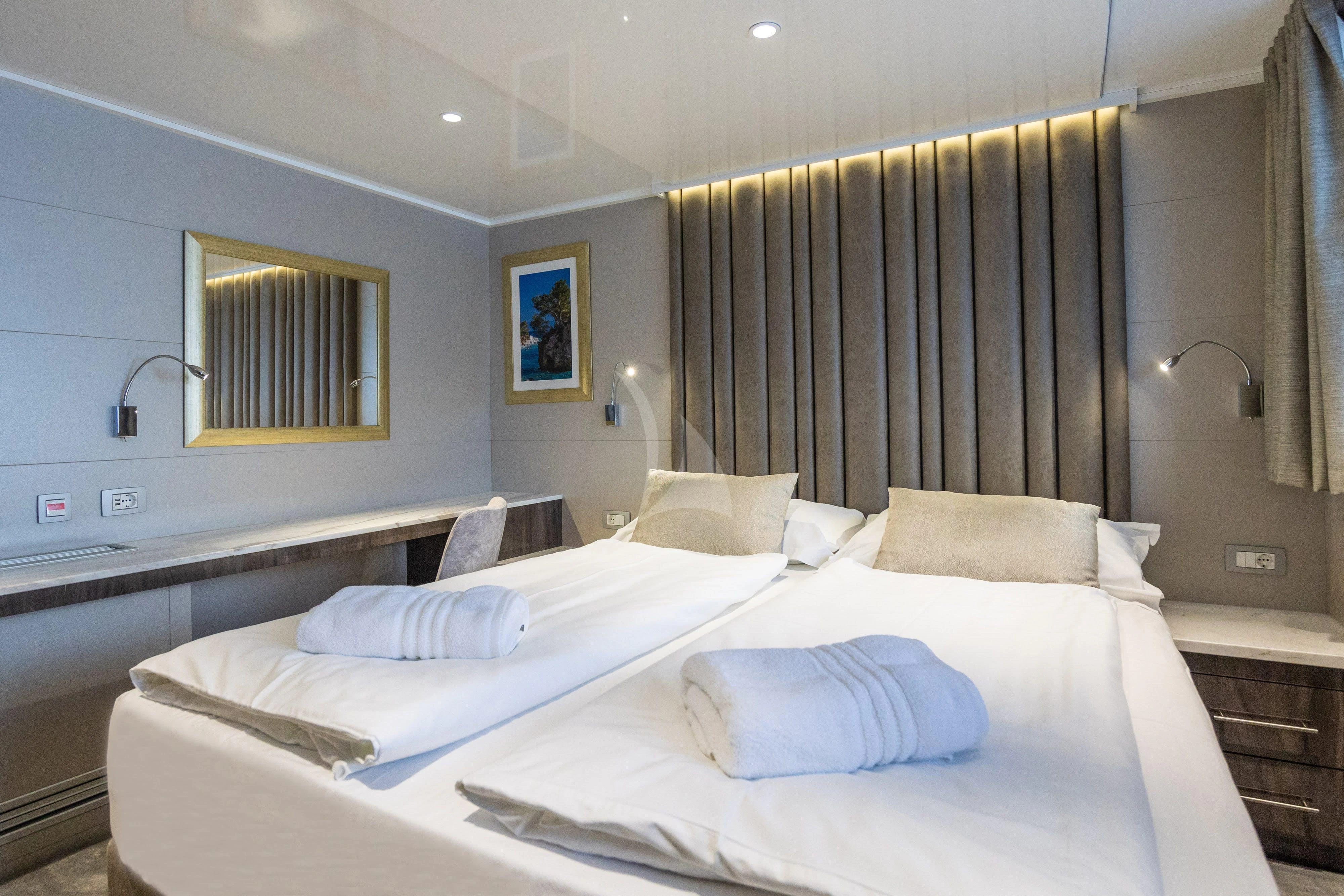 a room with a bed and a mirror aboard LADY ELEGANZA Yacht for Sale
