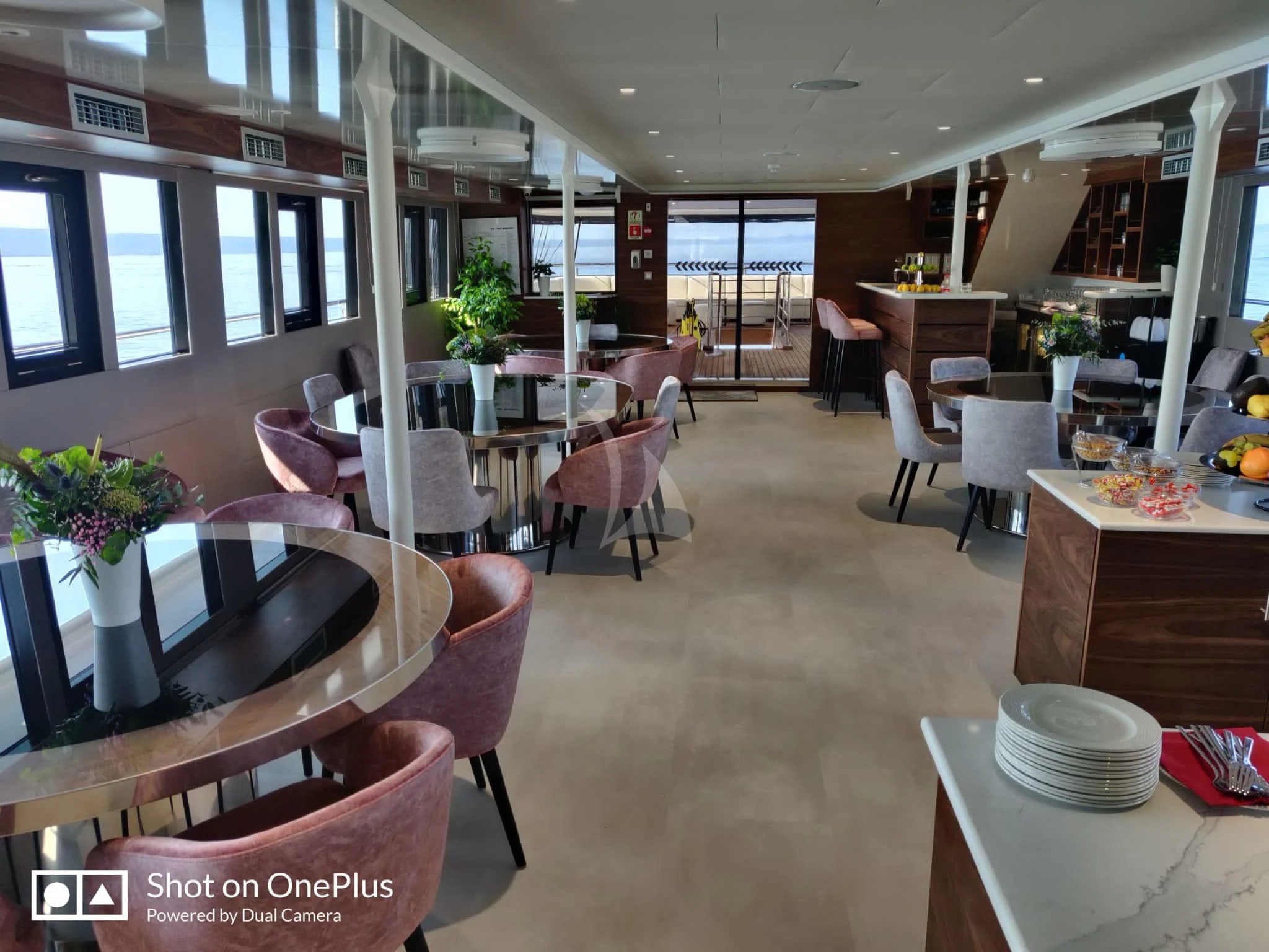 a room with tables and chairs aboard LADY ELEGANZA Yacht for Sale
