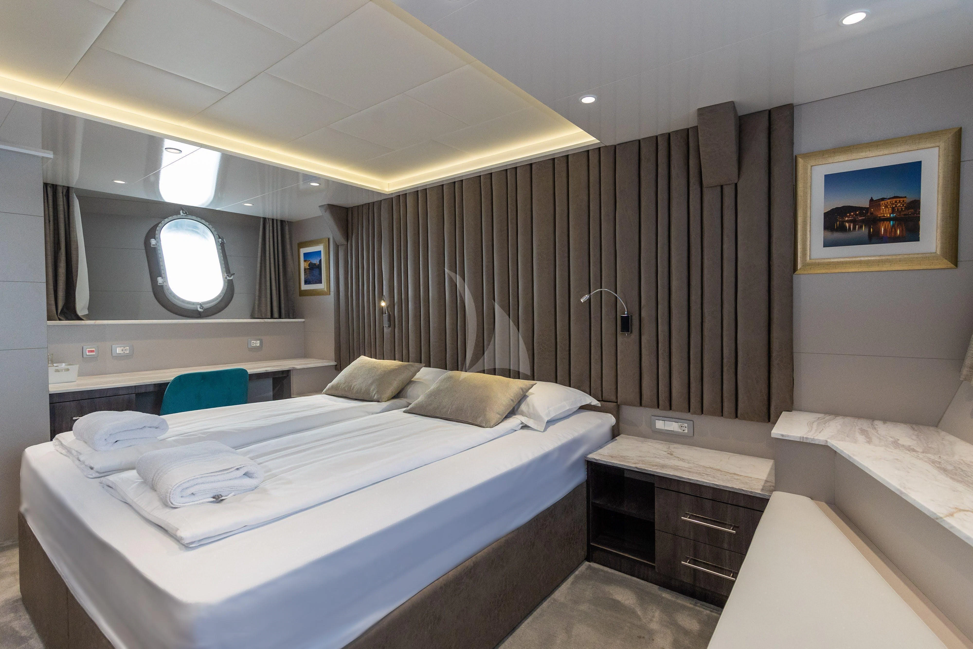 a room with a bed and a mirror aboard LADY ELEGANZA Yacht for Sale