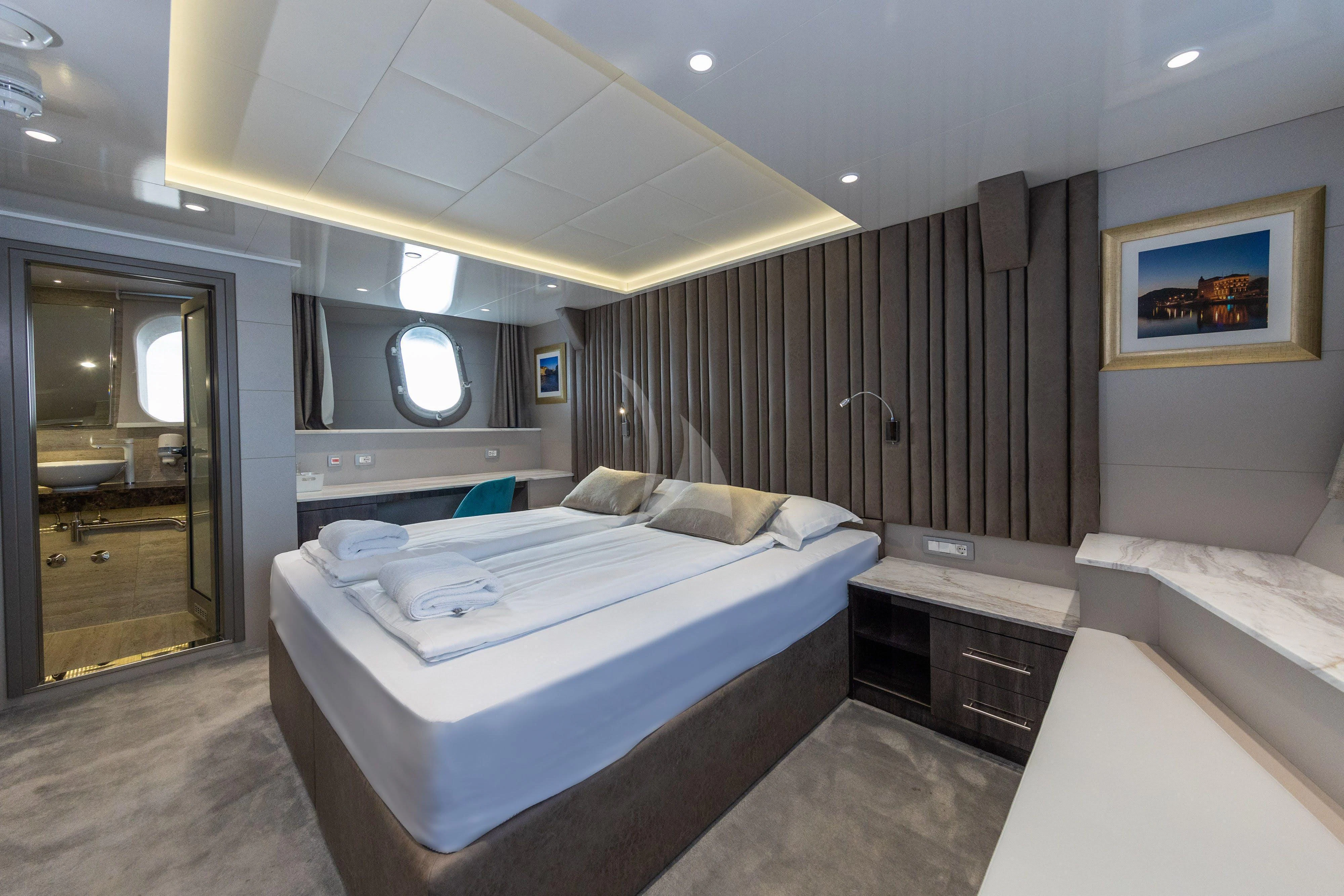 a room with a couple of beds aboard LADY ELEGANZA Yacht for Sale