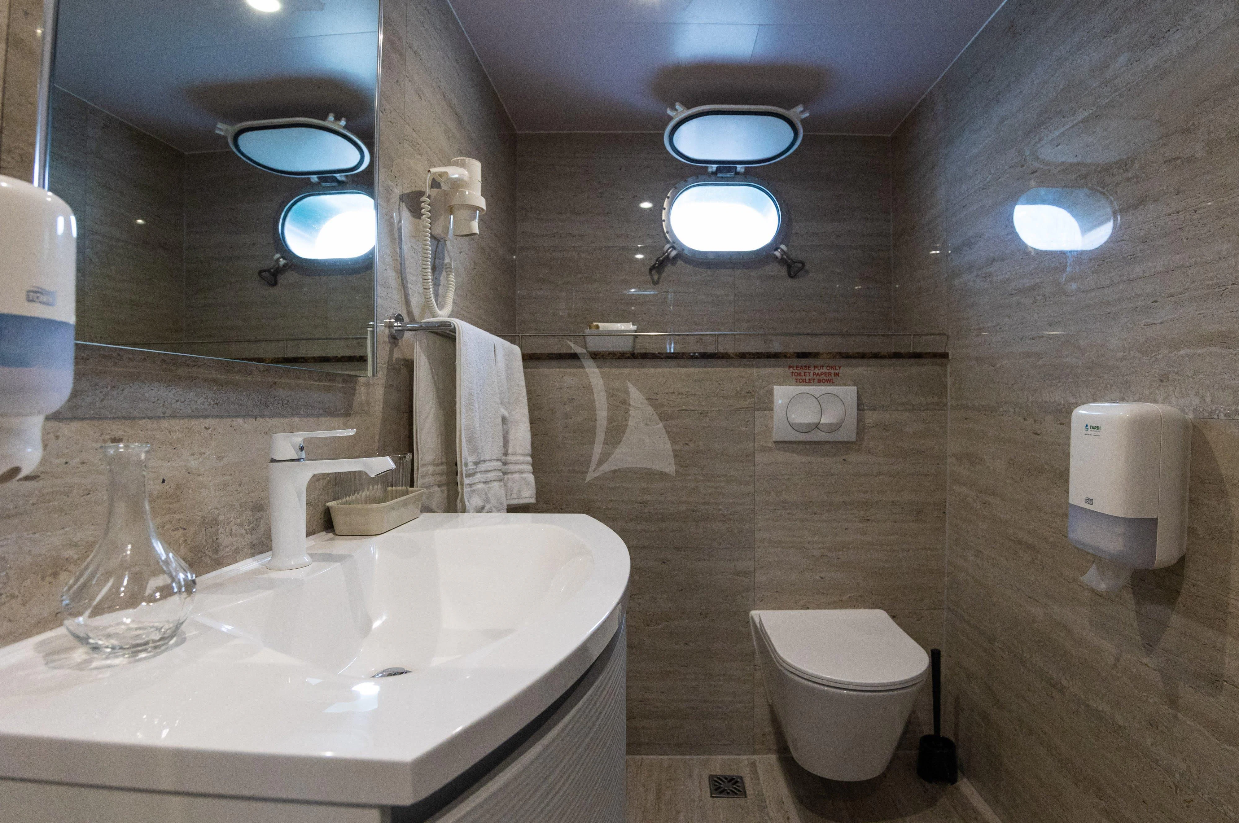 a bathroom with a sink toilet and a mirror aboard LADY ELEGANZA Yacht for Sale