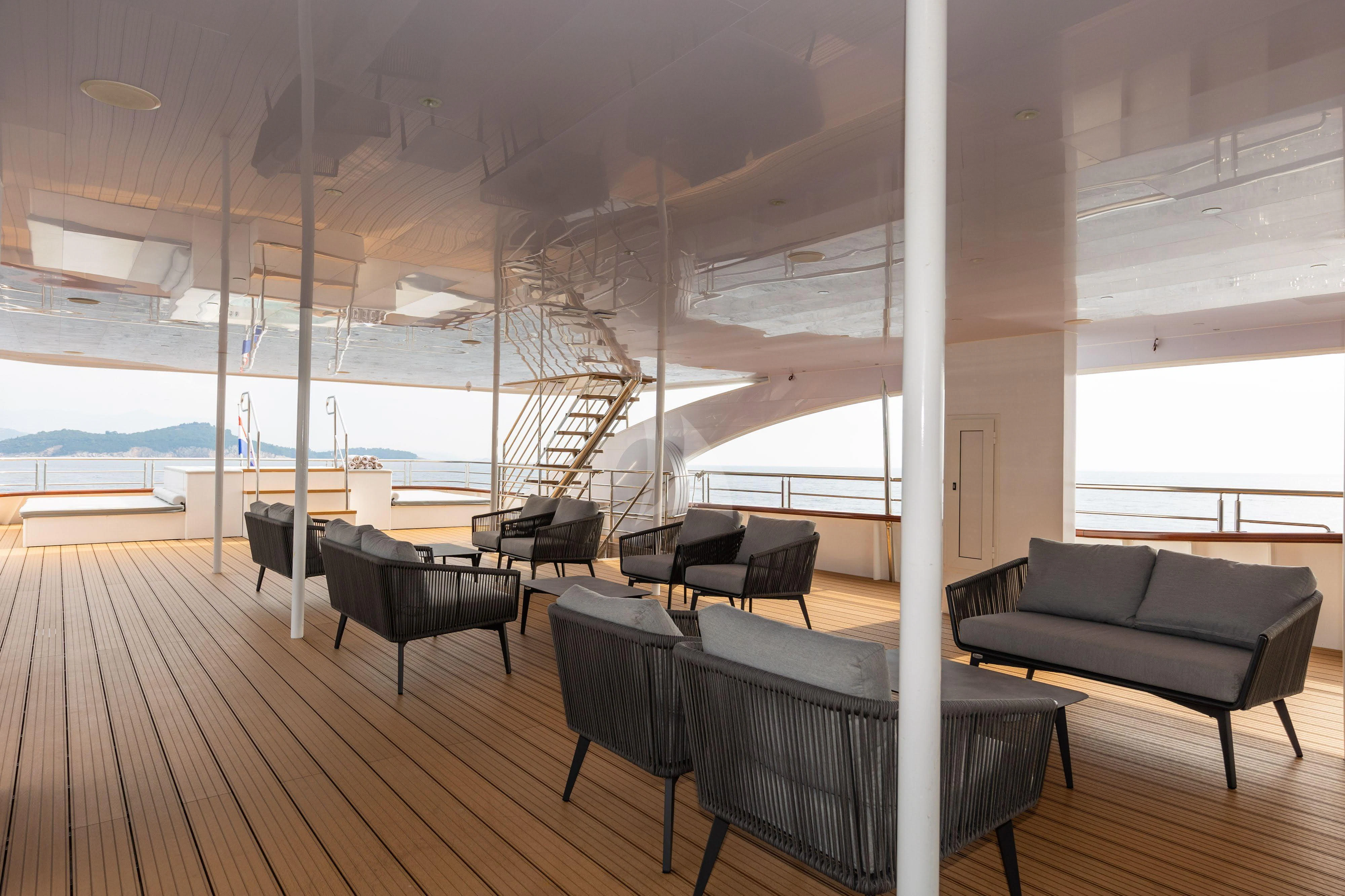 a room with a large window and a wood floor aboard LADY ELEGANZA Yacht for Sale