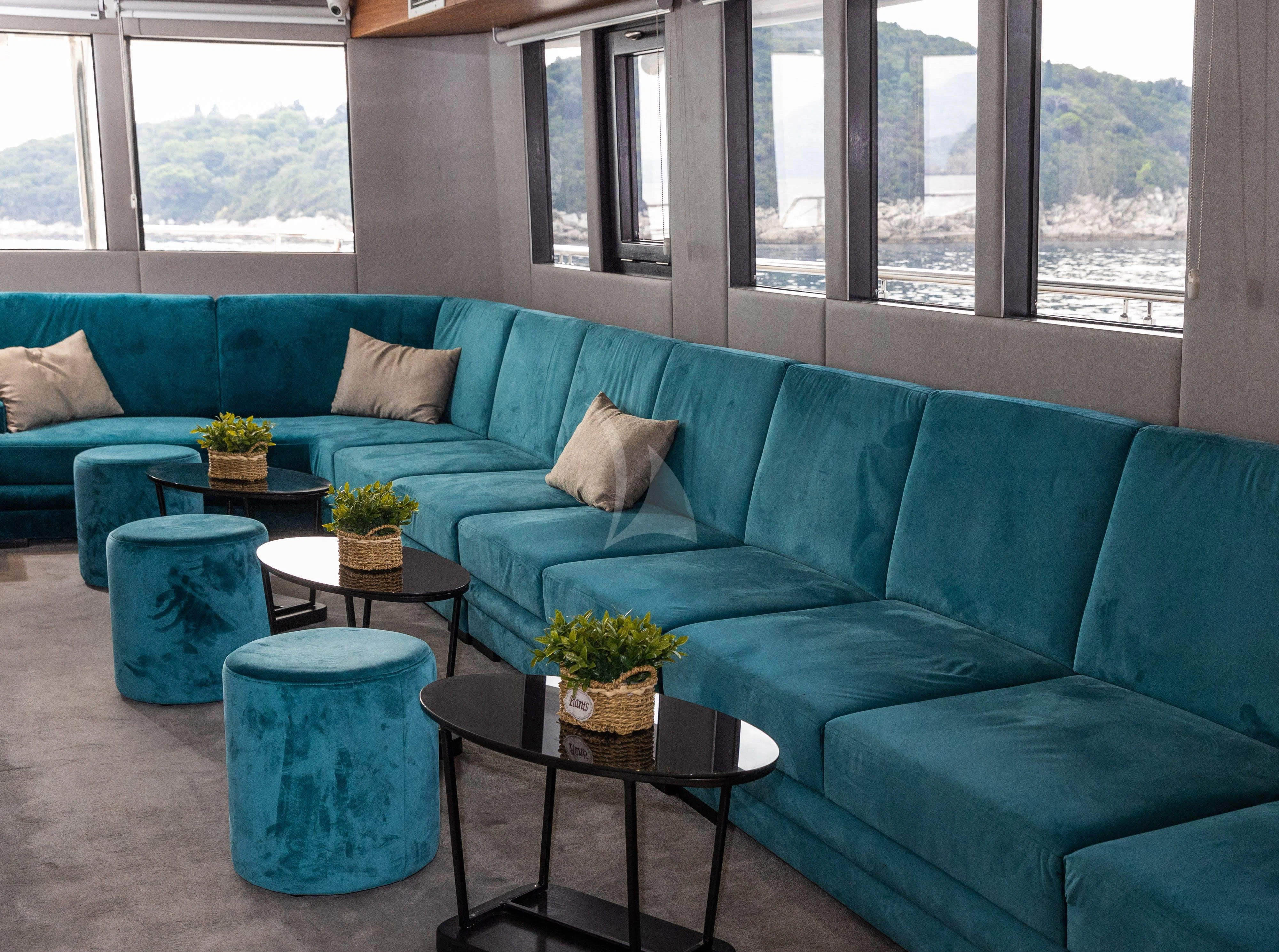 a couch with a coffee table aboard LADY ELEGANZA Yacht for Sale
