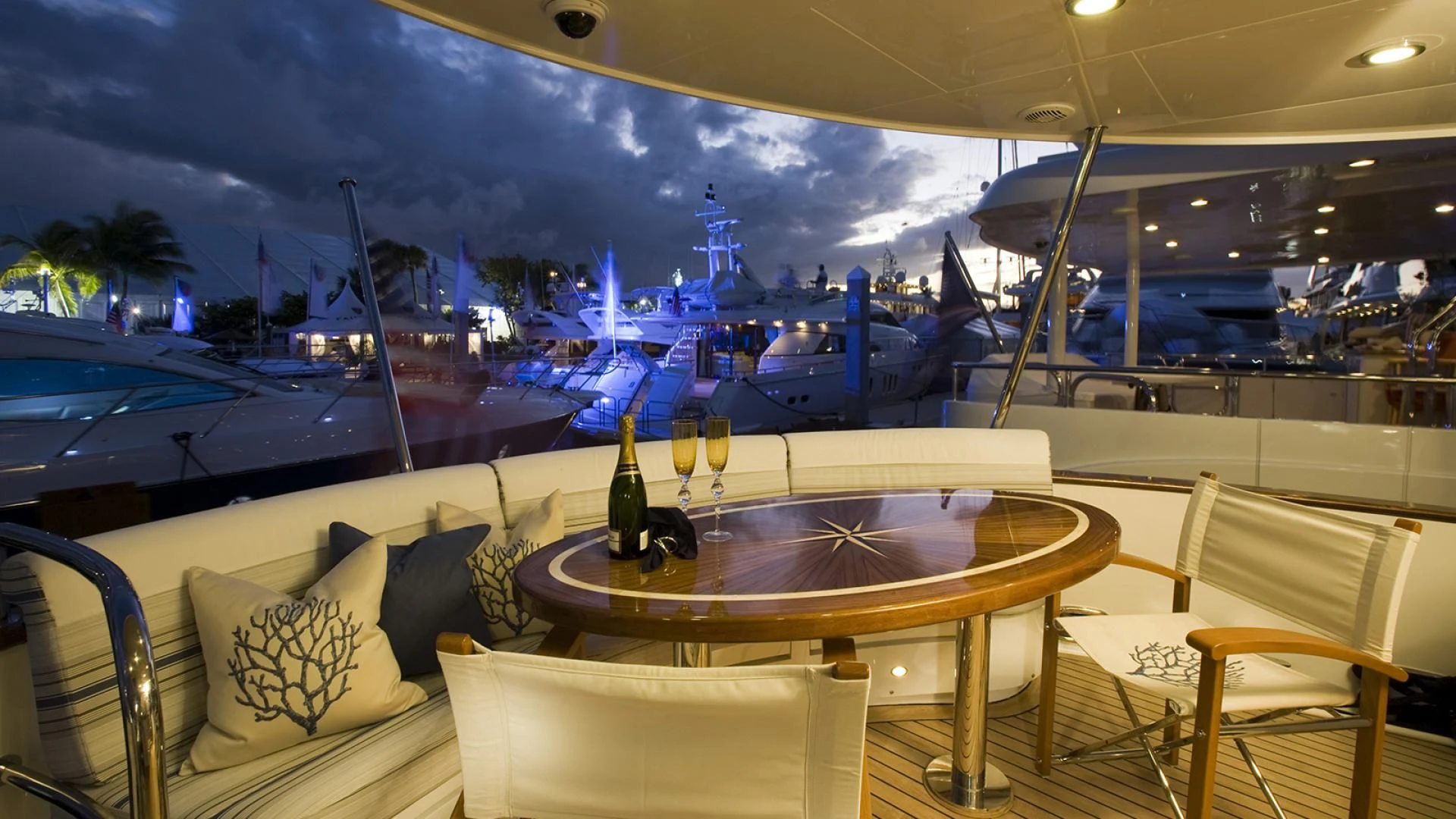 a table with glasses and a bottle of wine on a boat aboard ST. TROPEZ Yacht for Sale