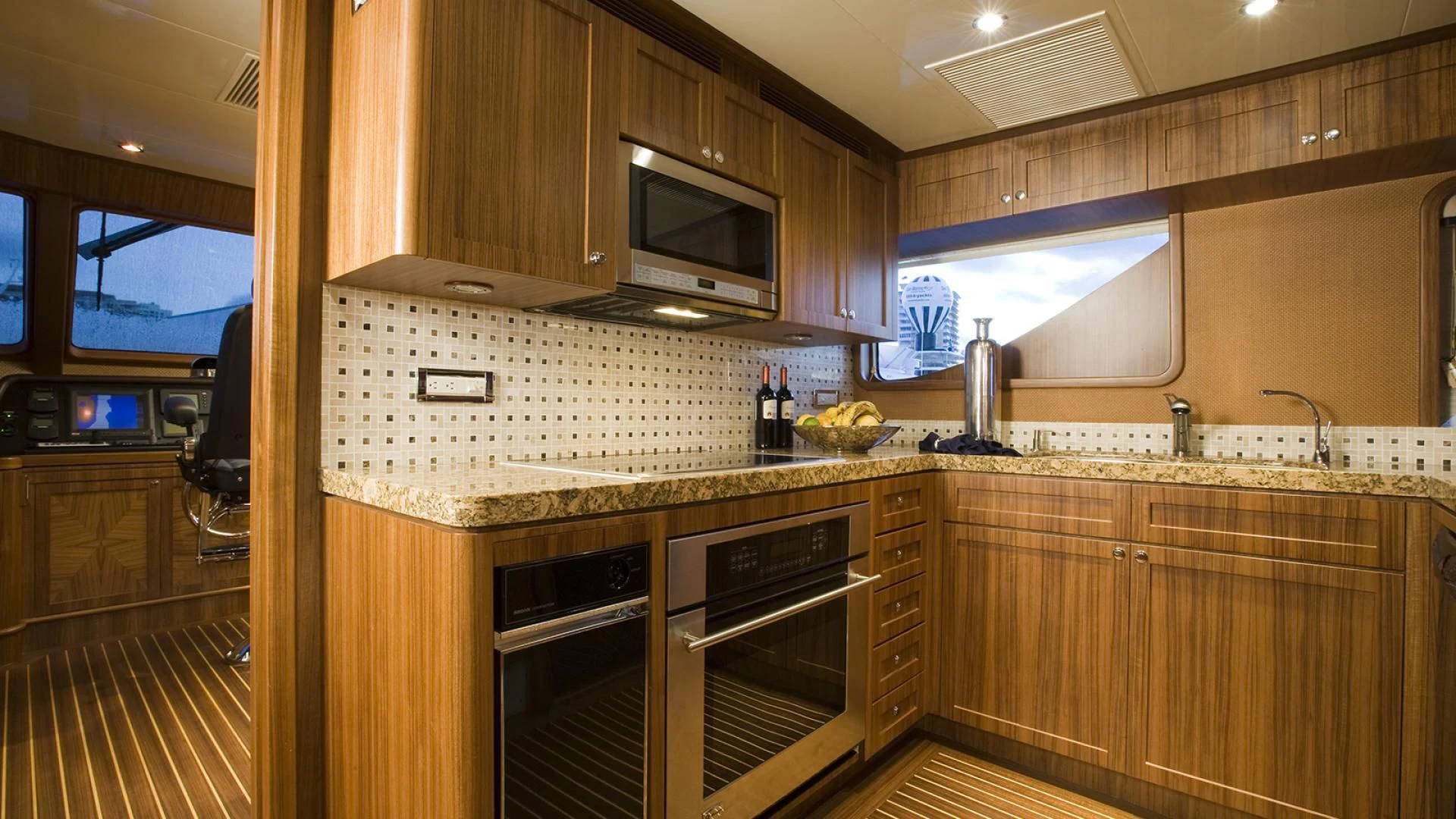 a kitchen with wooden cabinets aboard ST. TROPEZ Yacht for Sale