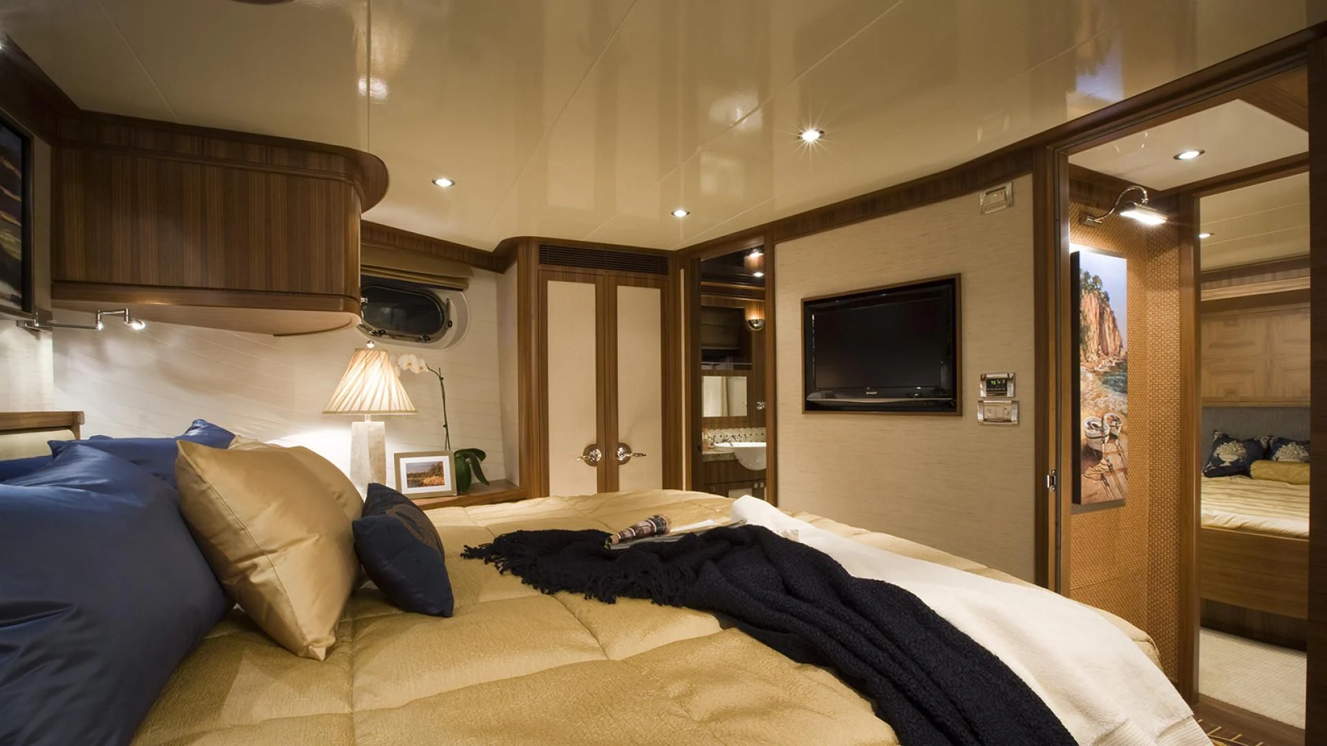 a bedroom with a bed and a television aboard ST. TROPEZ Yacht for Sale