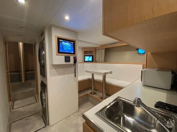 a kitchen with a sink and a tv on the wall aboard SELIN Yacht for Sale