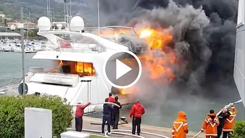 a group of people standing next to a large white ship on fire aboard LADY VANILLA Yacht for Sale