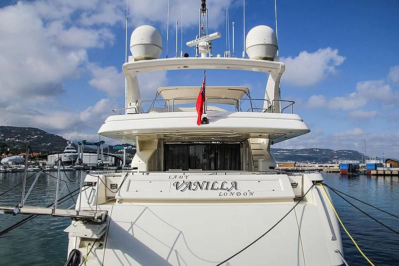 a white boat with a red stripe on the front aboard LADY VANILLA Yacht for Sale
