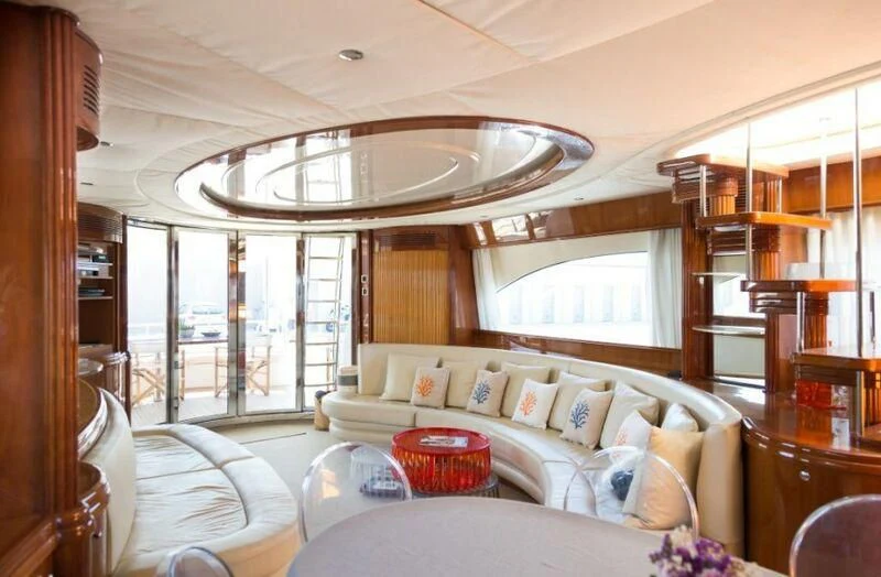 a living room with a large chandelier aboard NISAN Yacht for Sale