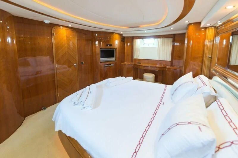 a room with beds and a television aboard NISAN Yacht for Sale