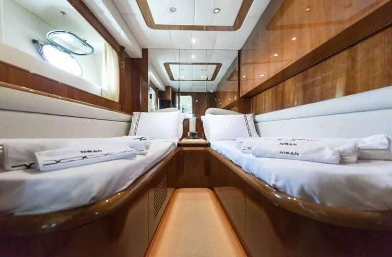 a room with beds and a window aboard NISAN Yacht for Sale