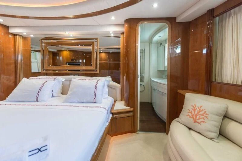 a bedroom with a bed and a mirror aboard NISAN Yacht for Sale
