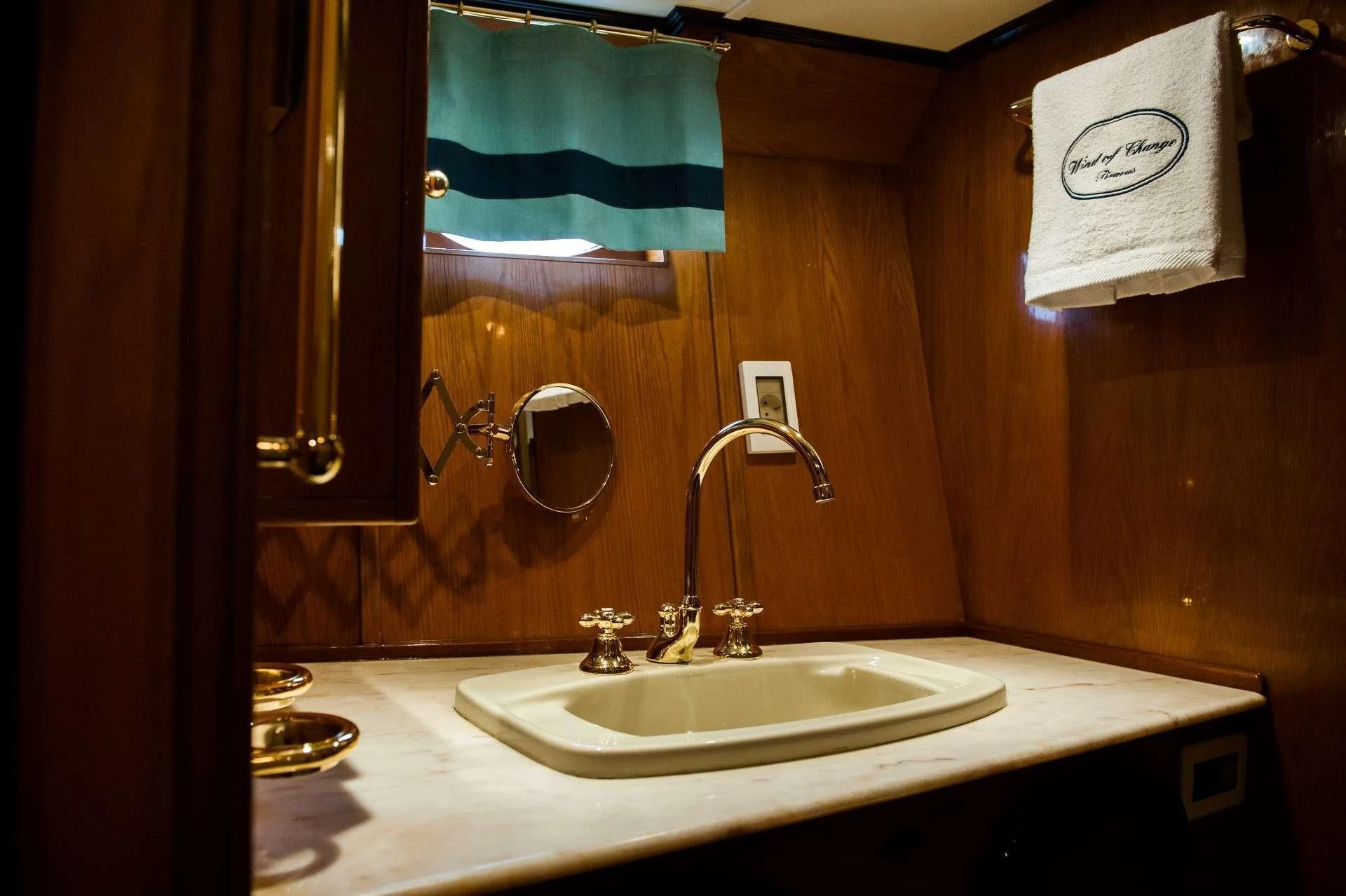 a bathroom with a sink and towels aboard WIND OF CHANGE Yacht for Charter