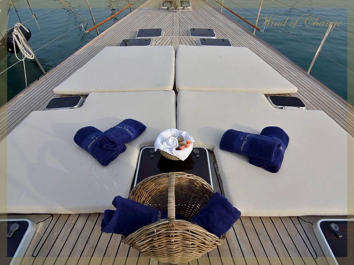 a boat with a table and chairs on it aboard WIND OF CHANGE Yacht for Charter