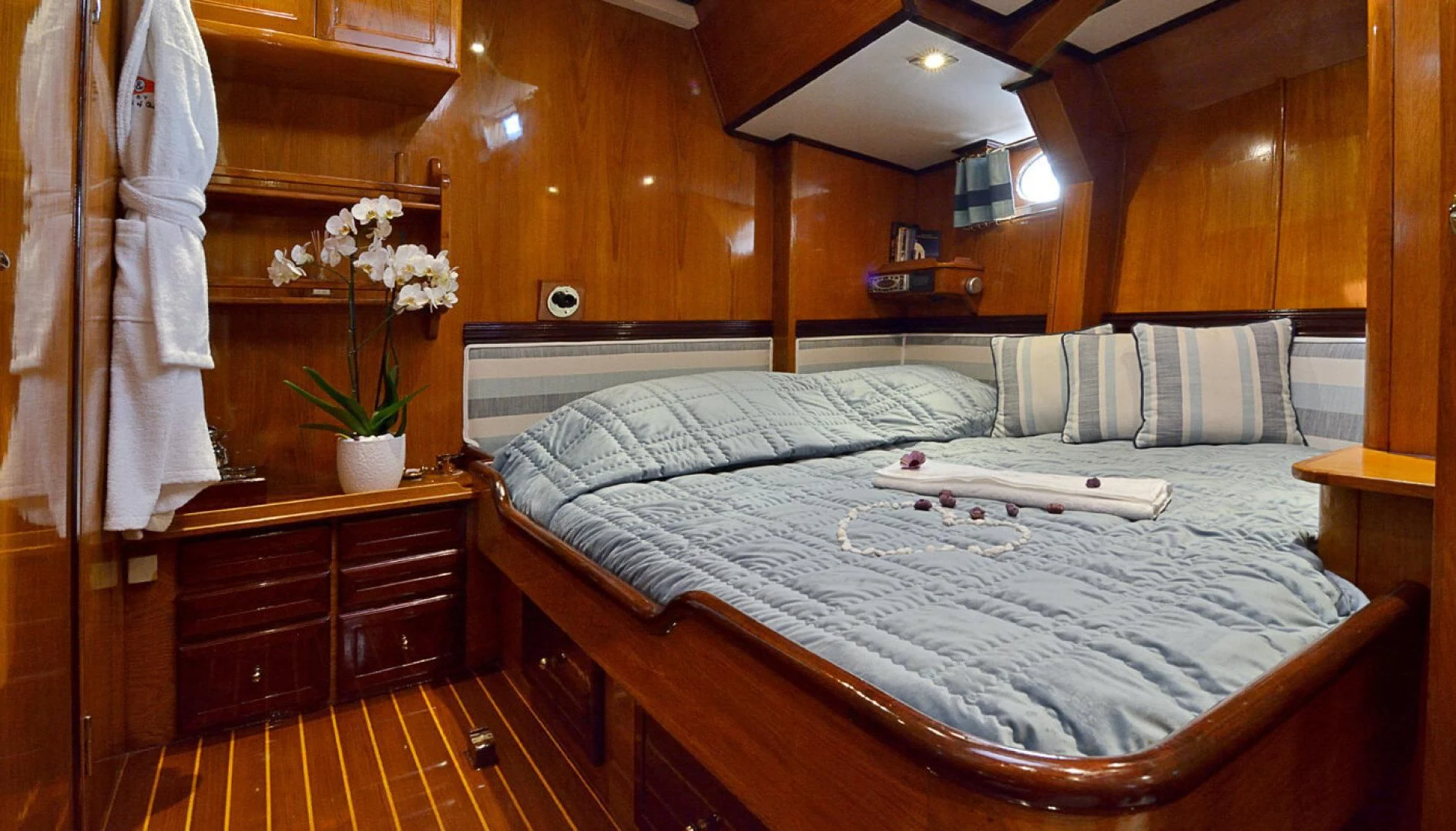 a bed with white sheets and pillows aboard WIND OF CHANGE Yacht for Charter