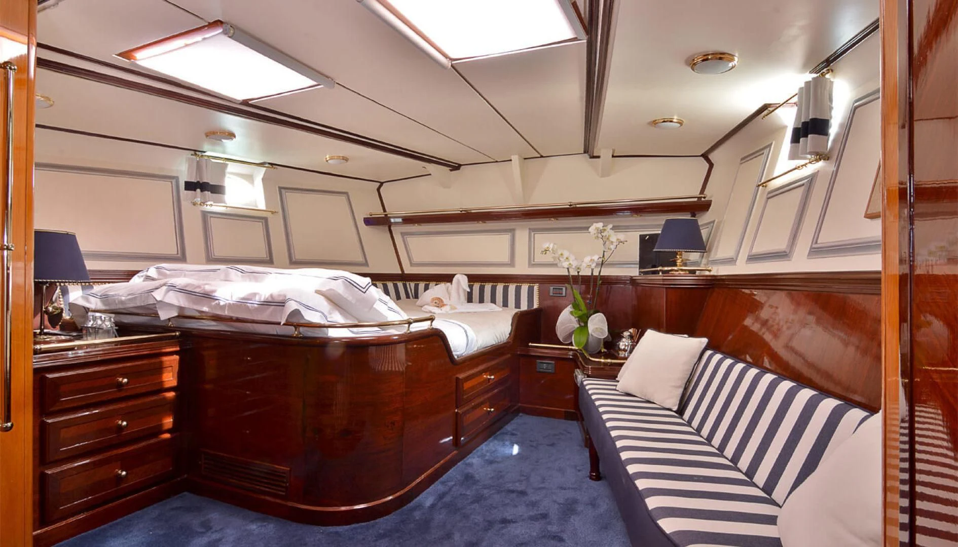 a room with a bed and a desk aboard WIND OF CHANGE Yacht for Charter