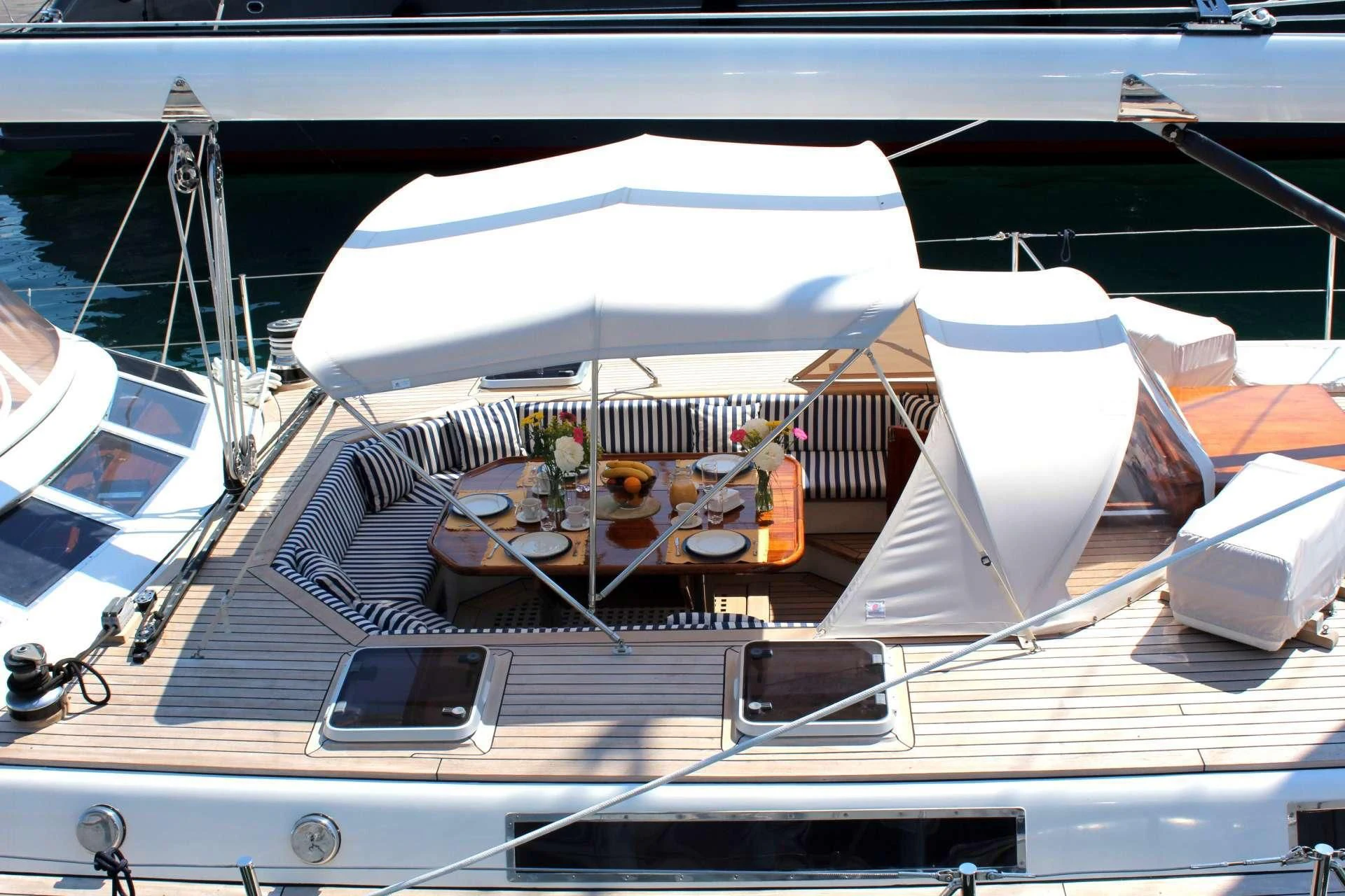 a boat with a table and chairs aboard WIND OF CHANGE Yacht for Charter