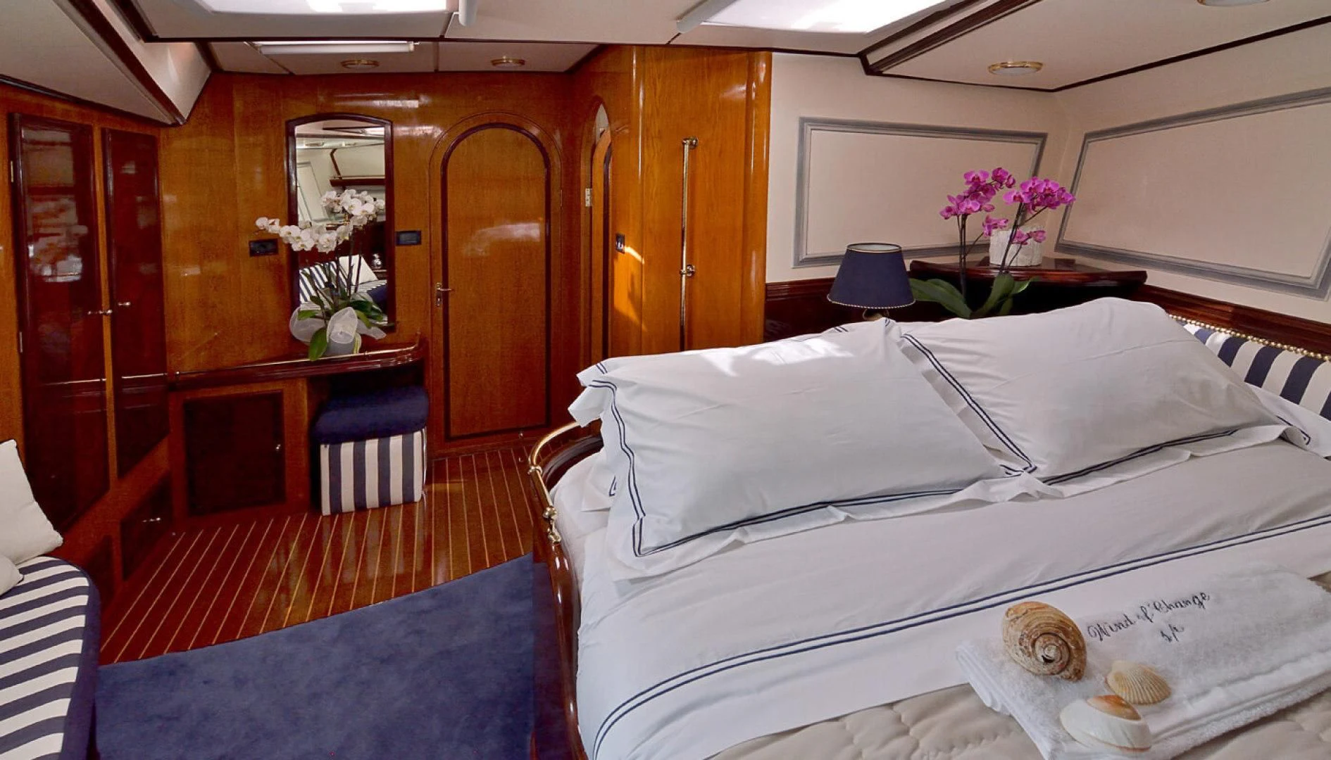 a room with a bed and a desk aboard WIND OF CHANGE Yacht for Charter