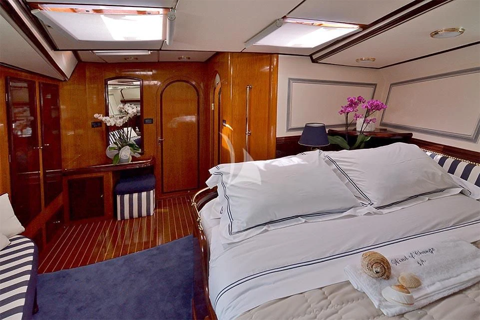 a room with a bed and a desk aboard WIND OF CHANGE Yacht for Charter