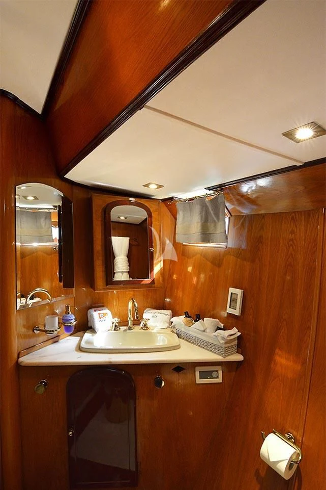 a bathroom with a sink and mirror aboard WIND OF CHANGE Yacht for Charter