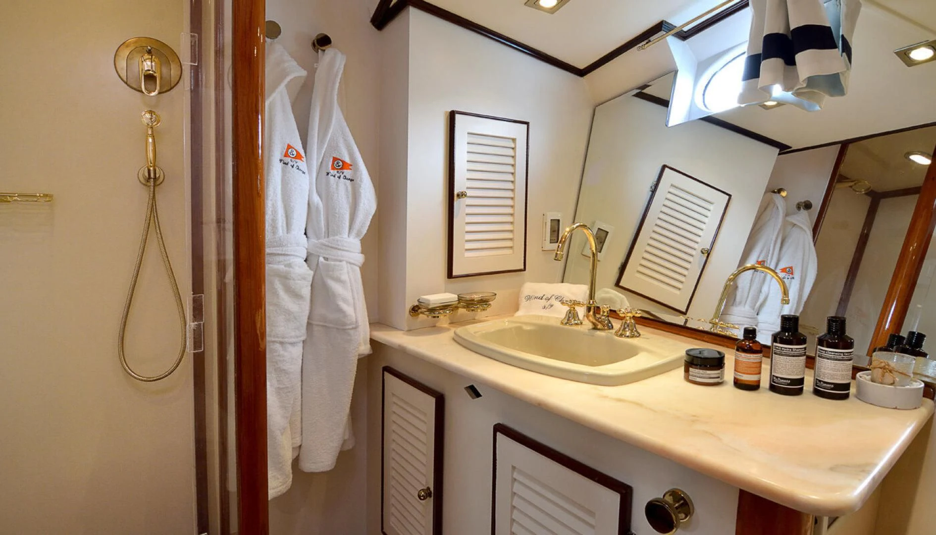 a bathroom with a robe on the wall aboard WIND OF CHANGE Yacht for Charter