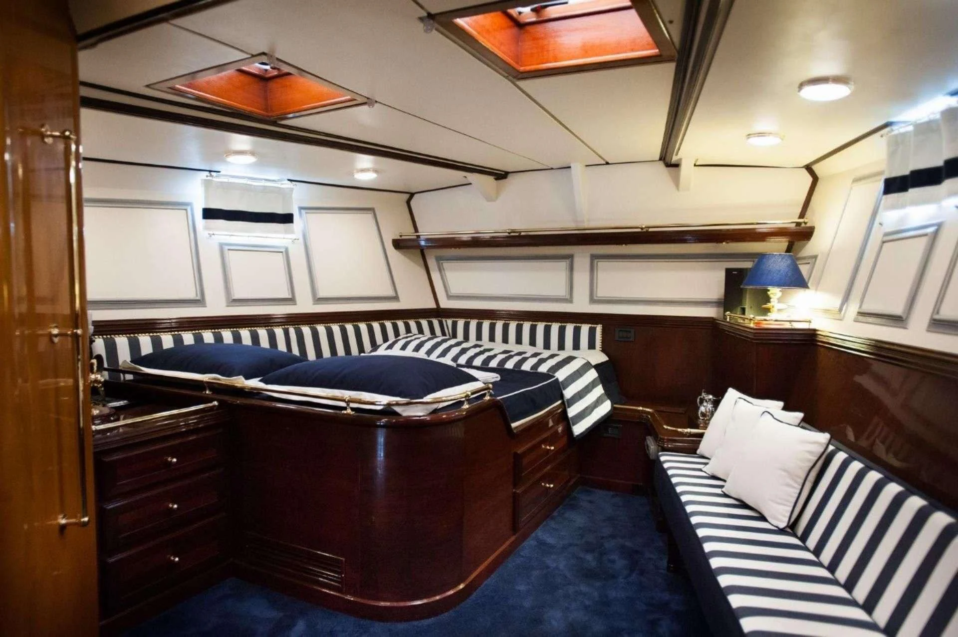 a room with a bed and a desk aboard WIND OF CHANGE Yacht for Charter
