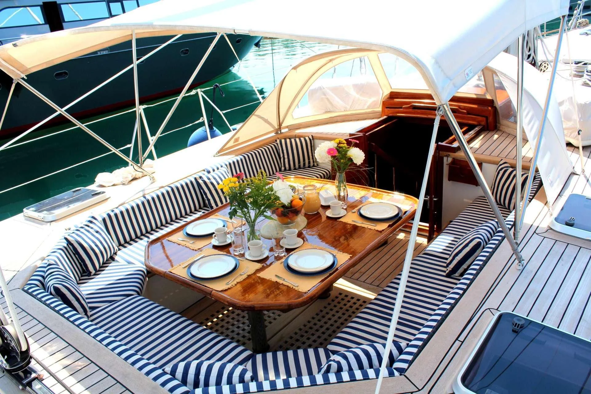 a table with plates and food on it aboard WIND OF CHANGE Yacht for Charter
