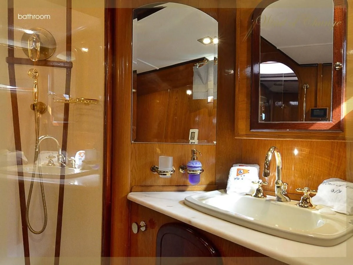 a bathroom with a sink and a mirror aboard WIND OF CHANGE Yacht for Charter