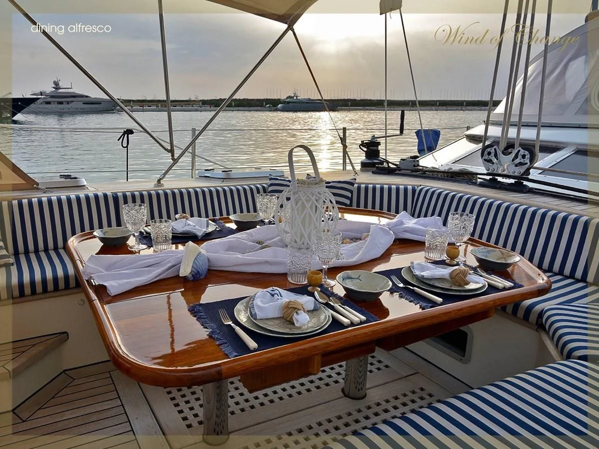 a table set for a meal on a boat aboard WIND OF CHANGE Yacht for Charter